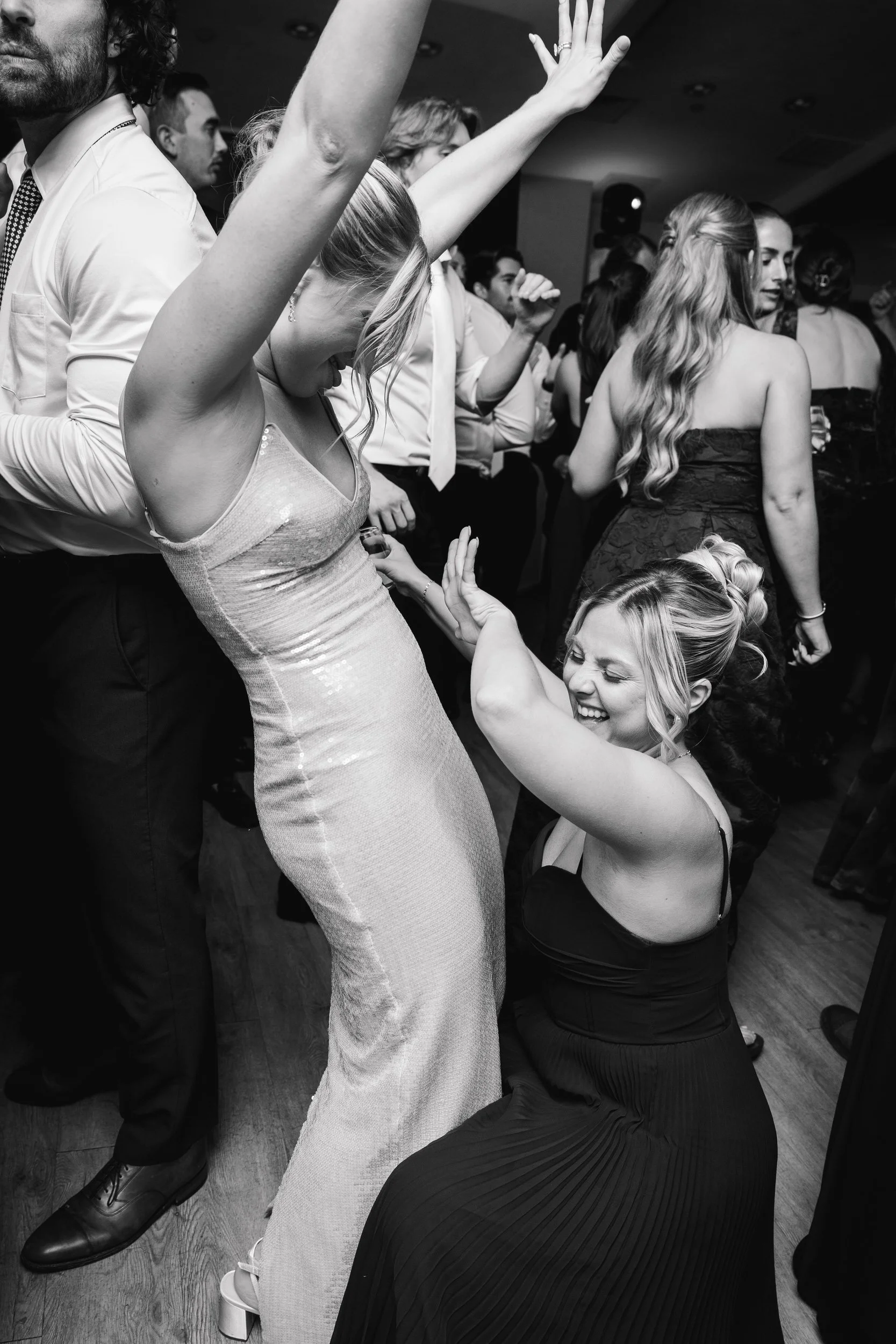Wedding guests dancing during a reception in the Ocean Room at Wychmere Beach Club.