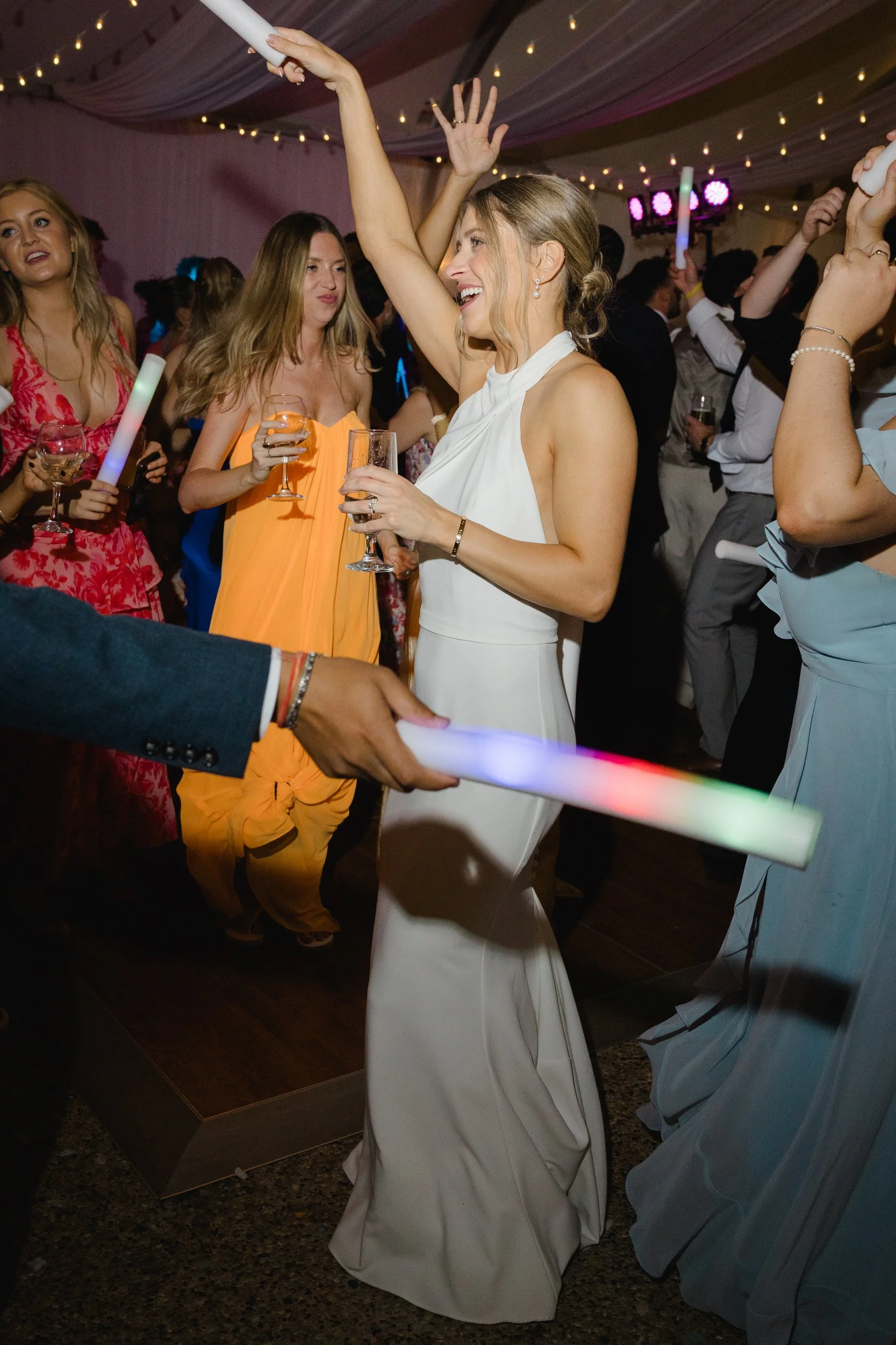 Packed dance floor during an elegant coastal wedding celebration.