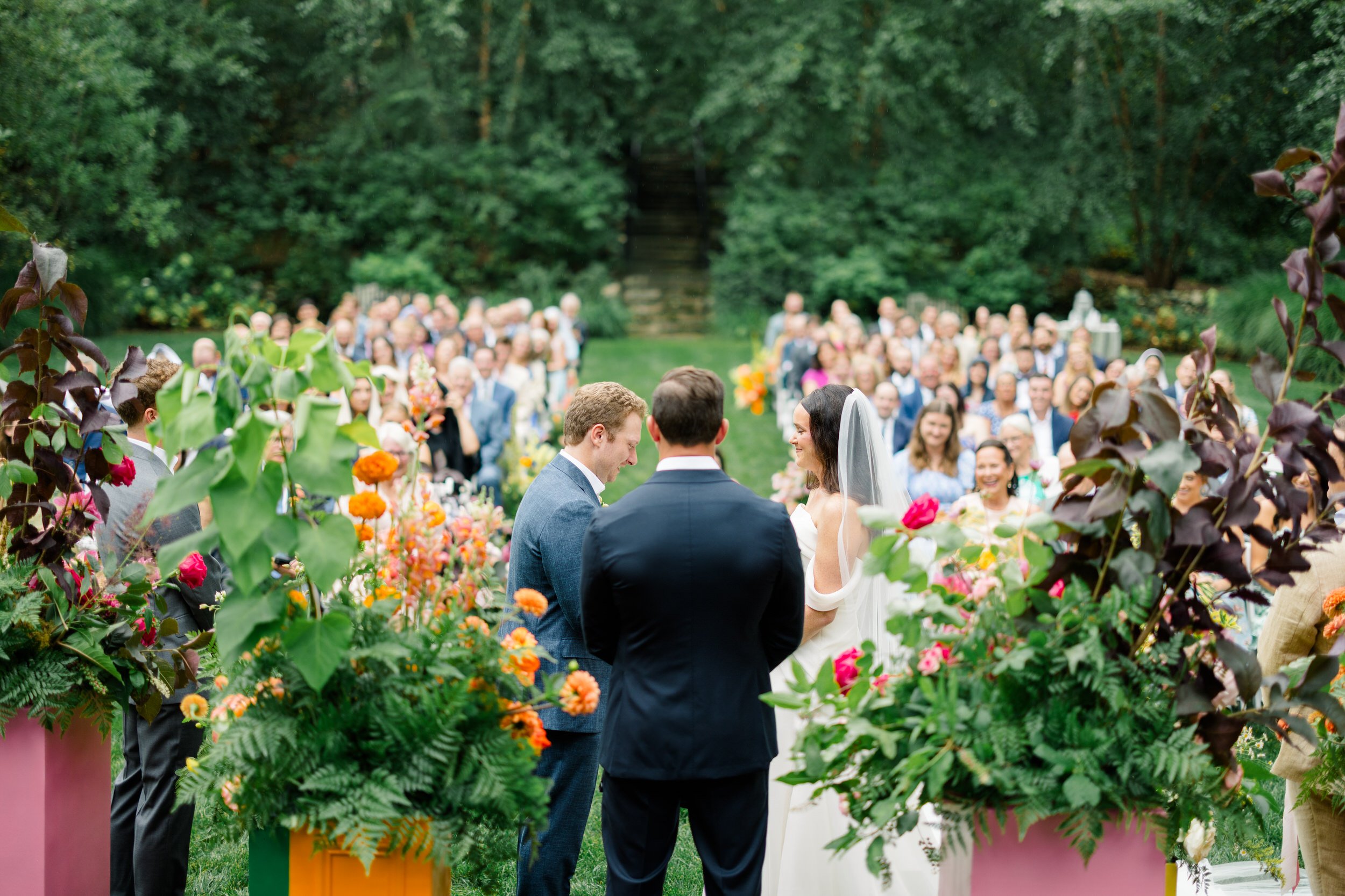 Romantic garden ceremony filled with colorful seasonal flowers at the Connors Center.
