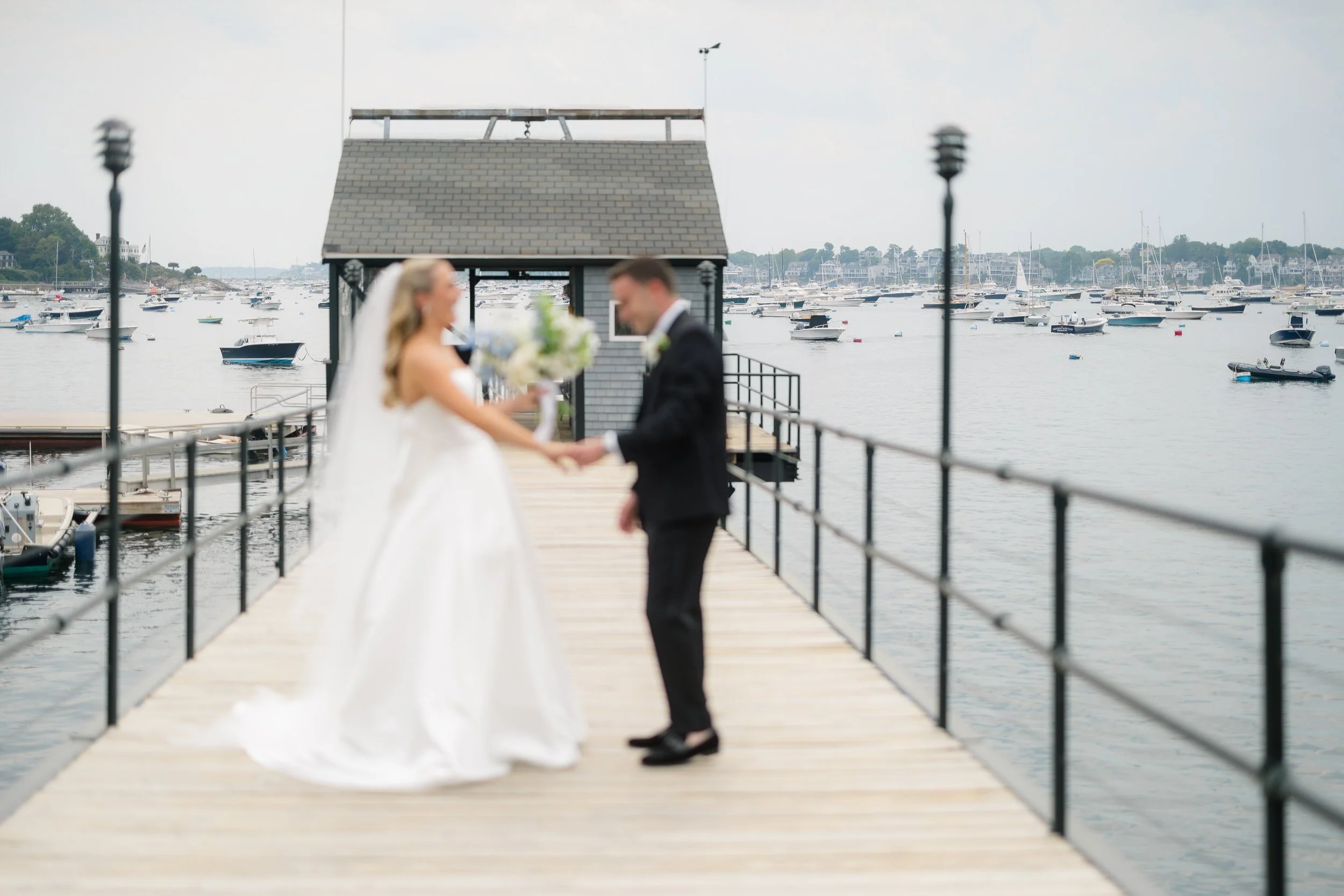 The couple exchanges private vows overlooking Marblehead Harbor during their Corinthian Yacht Club wedding.