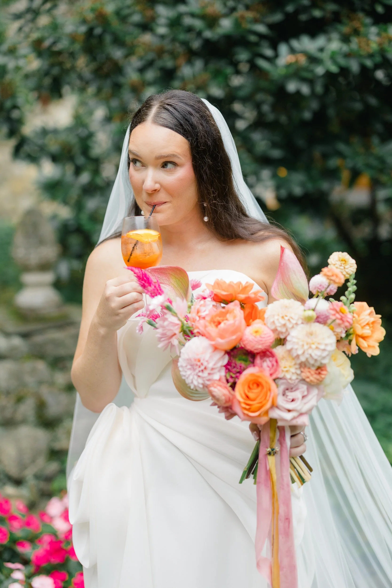Bright and colorful cocktail hour featuring seasonal flowers and playful wedding details.