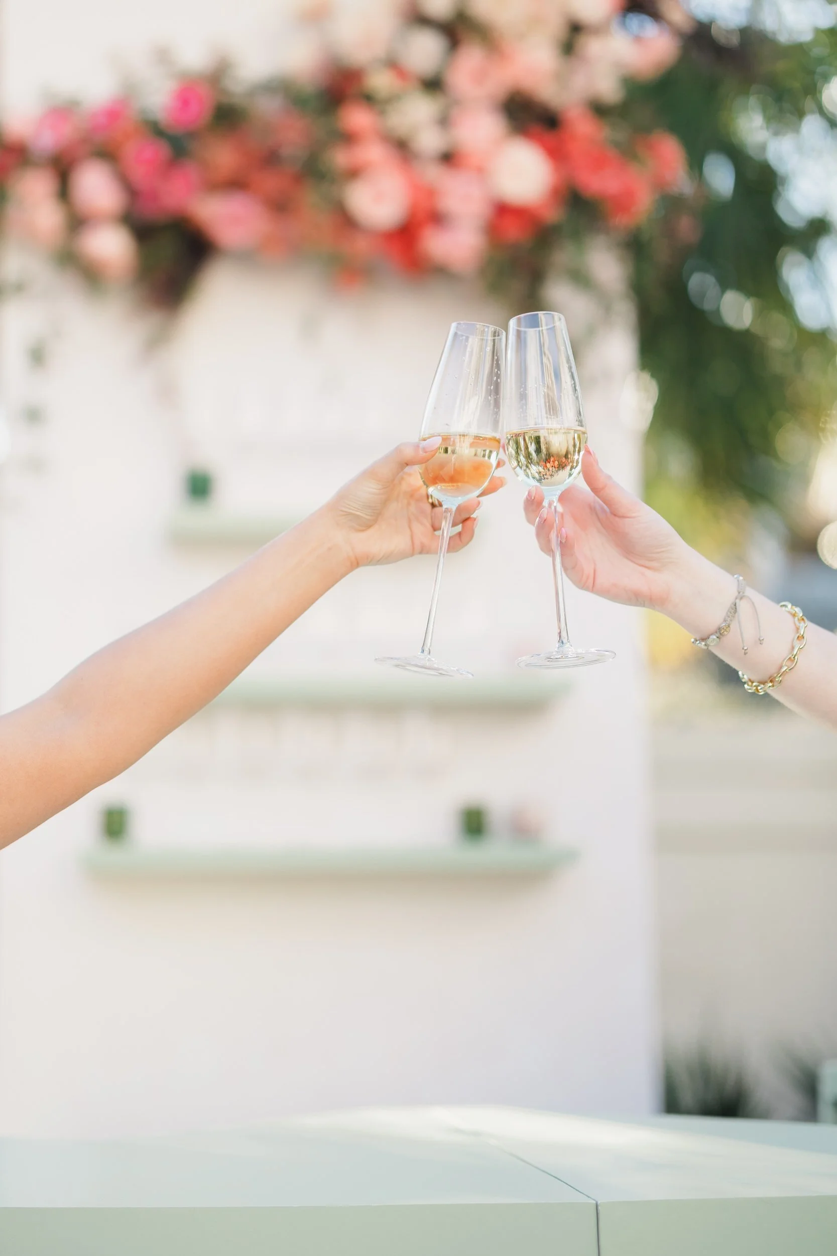 Spring wedding guests in bold pastel fashion celebrating during cocktail hour at The Gadsen House.