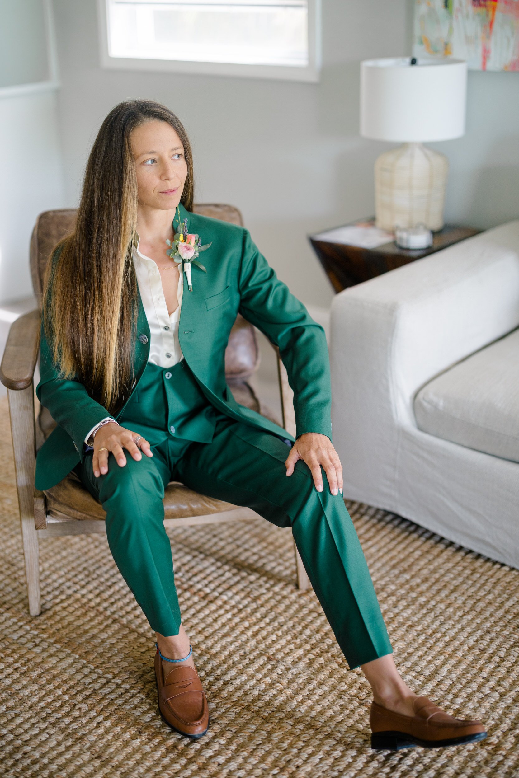 Tailored green bridal suit with abalone shell buttons inspired by the sea.