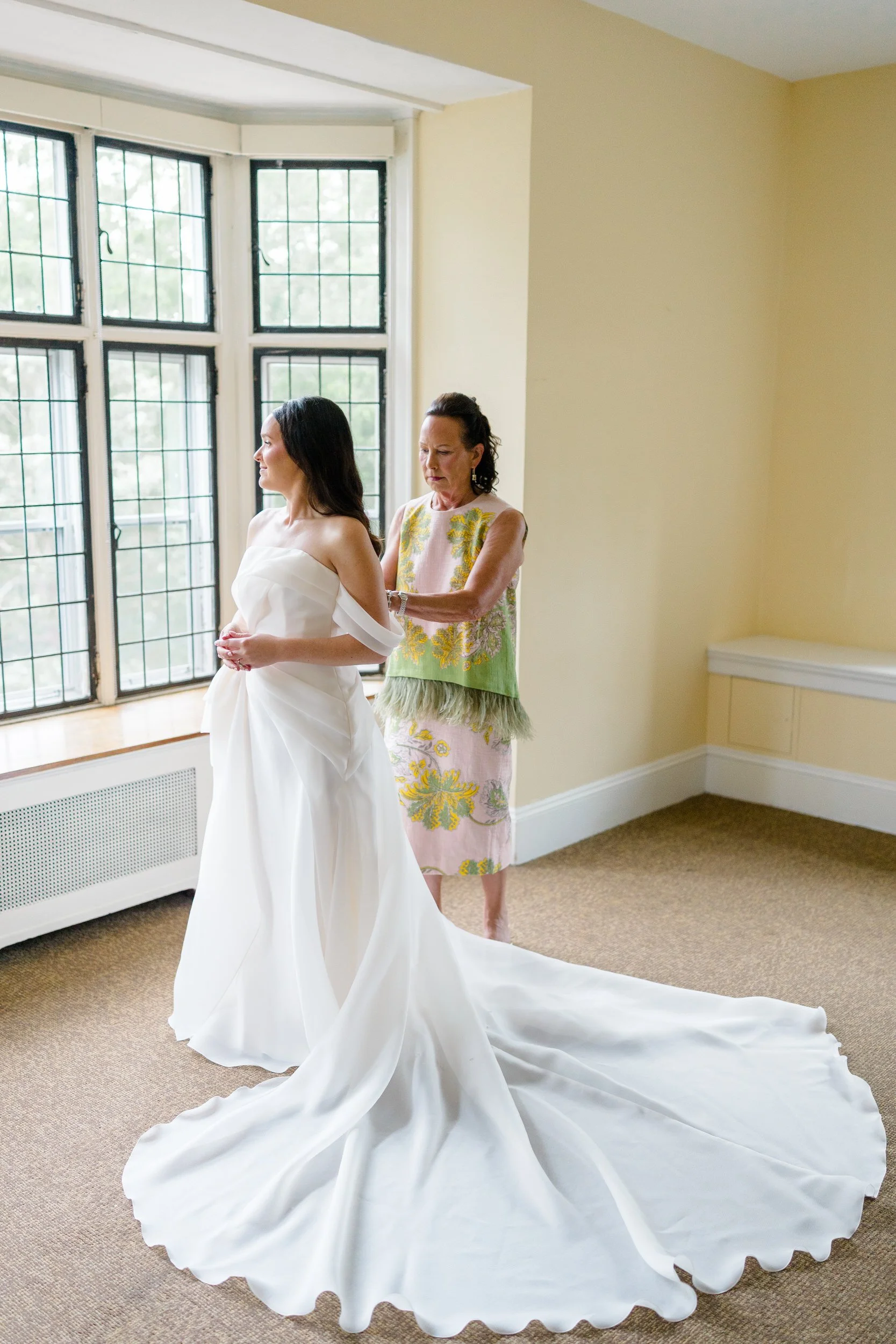 Bride preparing for her wedding in a colorful garden-inspired setting at the Connors Center.