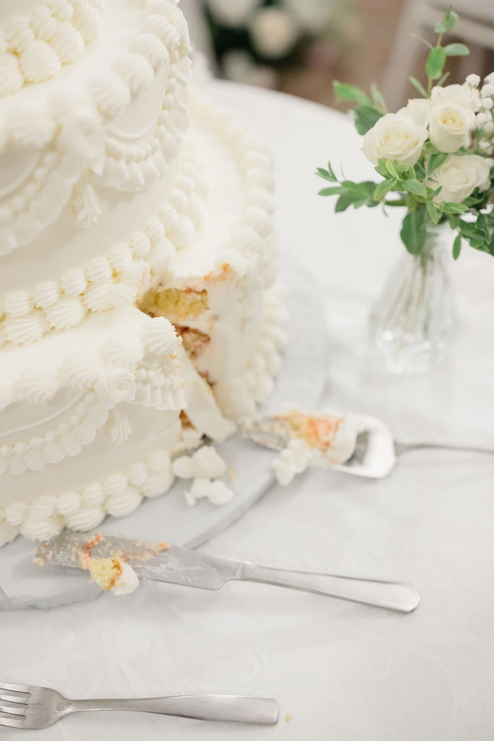 Couple sharing their first slice of wedding cake at their Massachusetts wedding.