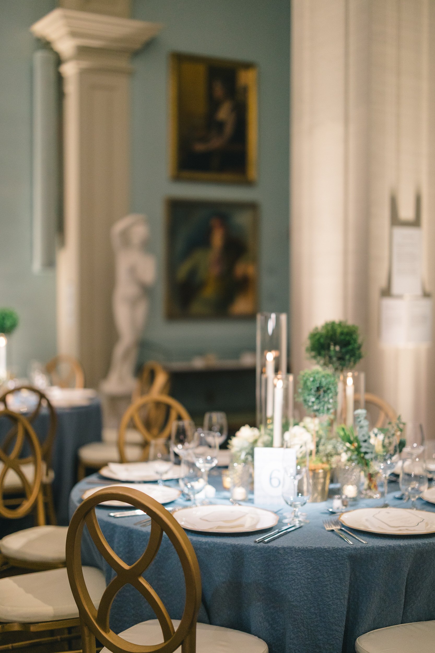 Close-up of a candlelit dinner setting at the Boston Athenaeum wedding rehearsal dinner