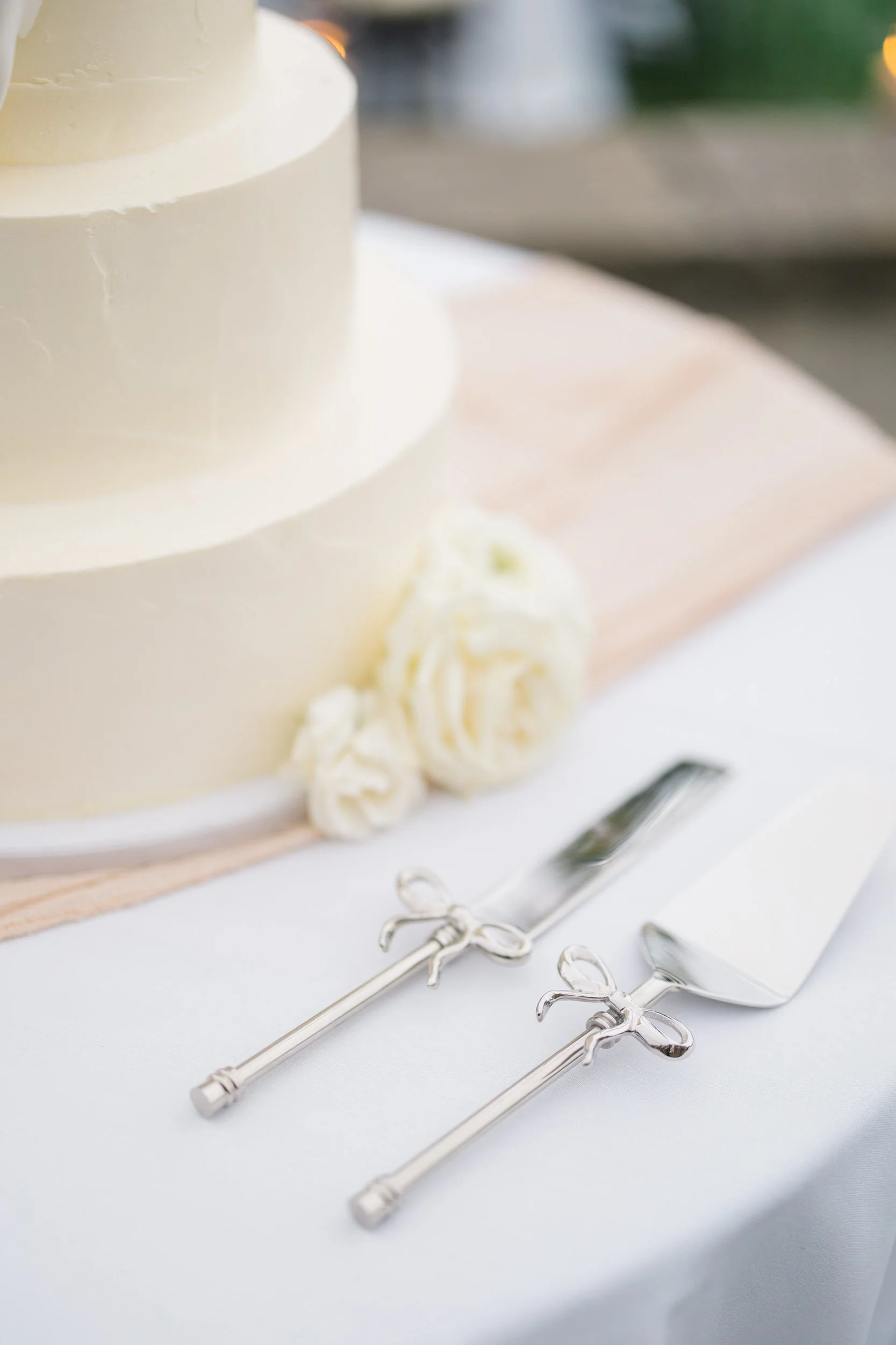 Wedding cake details styled for a romantic evening reception at Crane Estate in Ipswich.