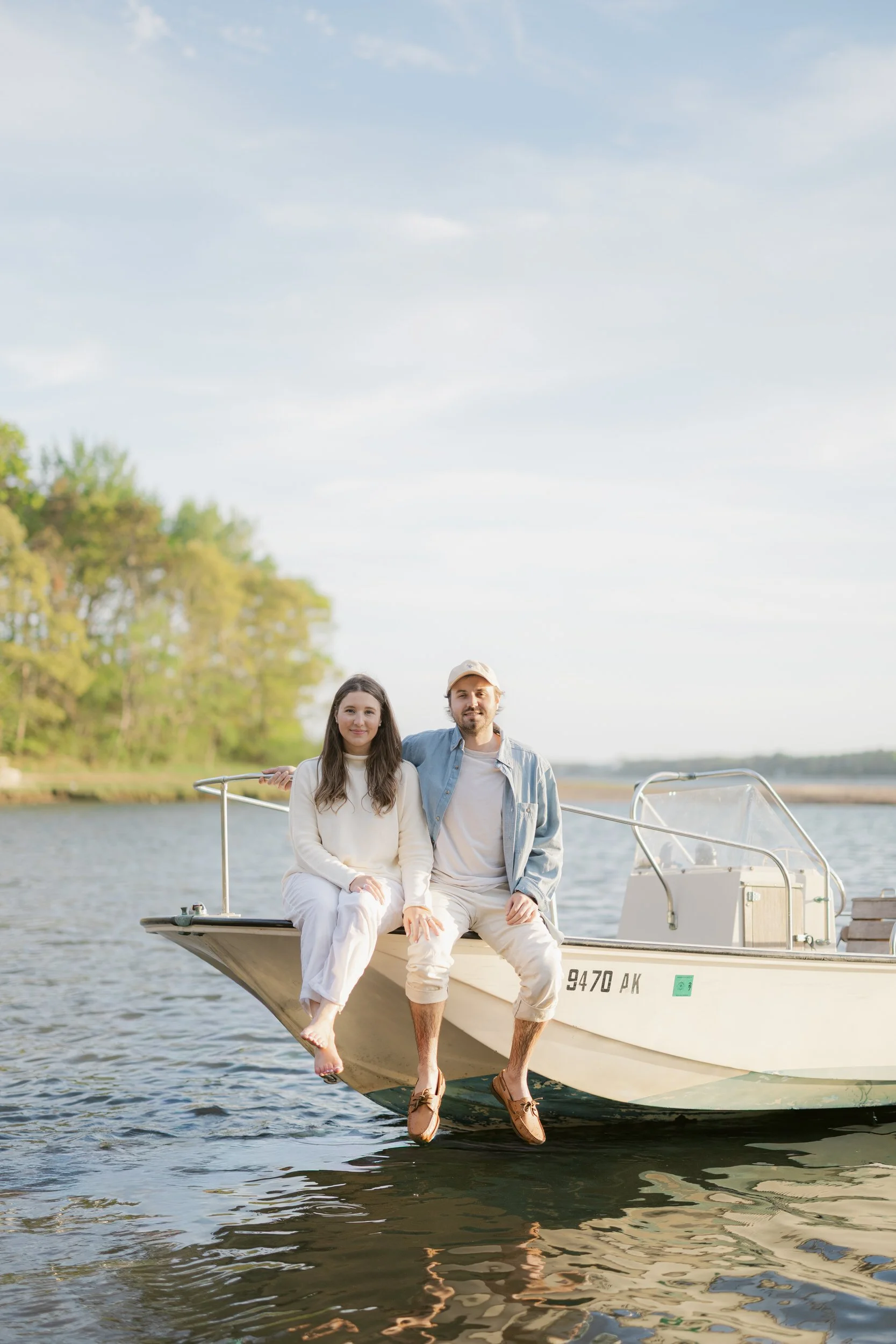 Chatham Cape Cod engagement session boat portraits with soft sunset reflections on the water.