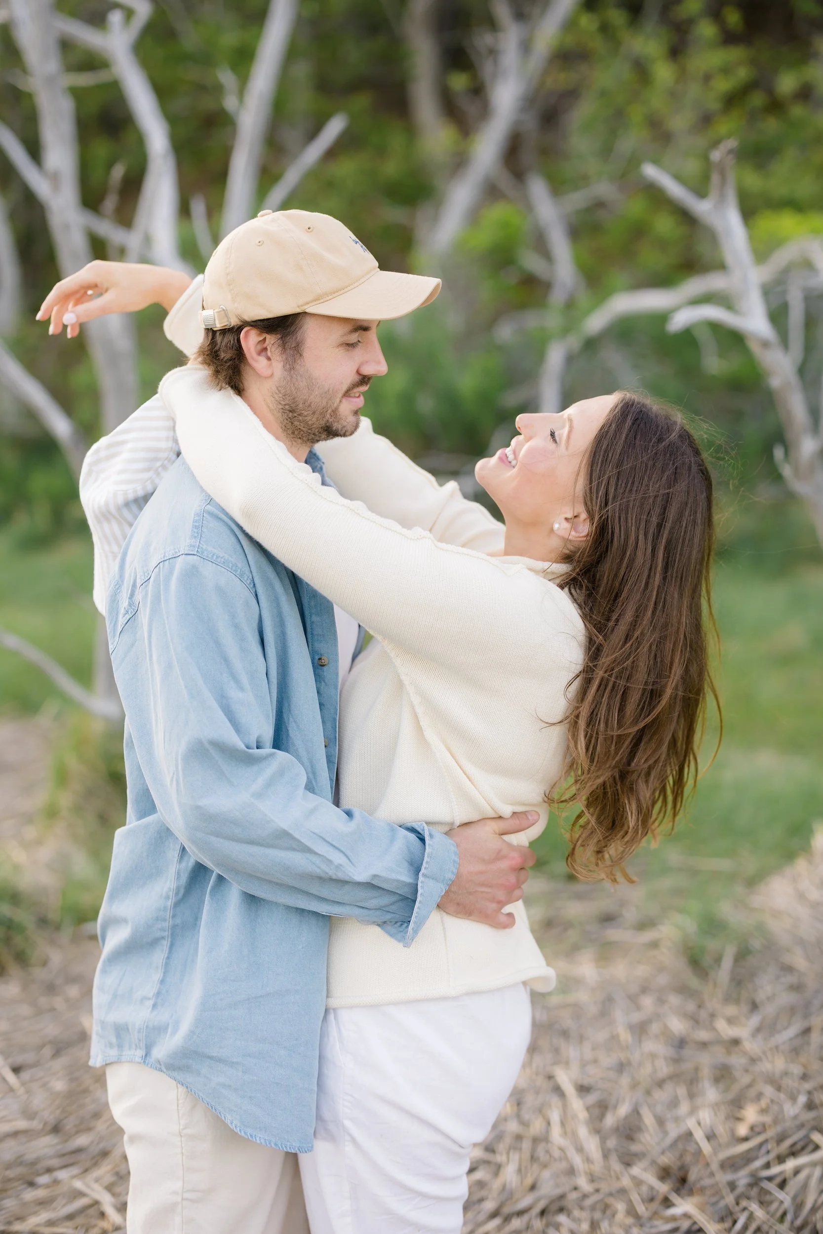 Cape Cod engagement session in Chatham with couple in neutral linen outfits walking along the shoreline.