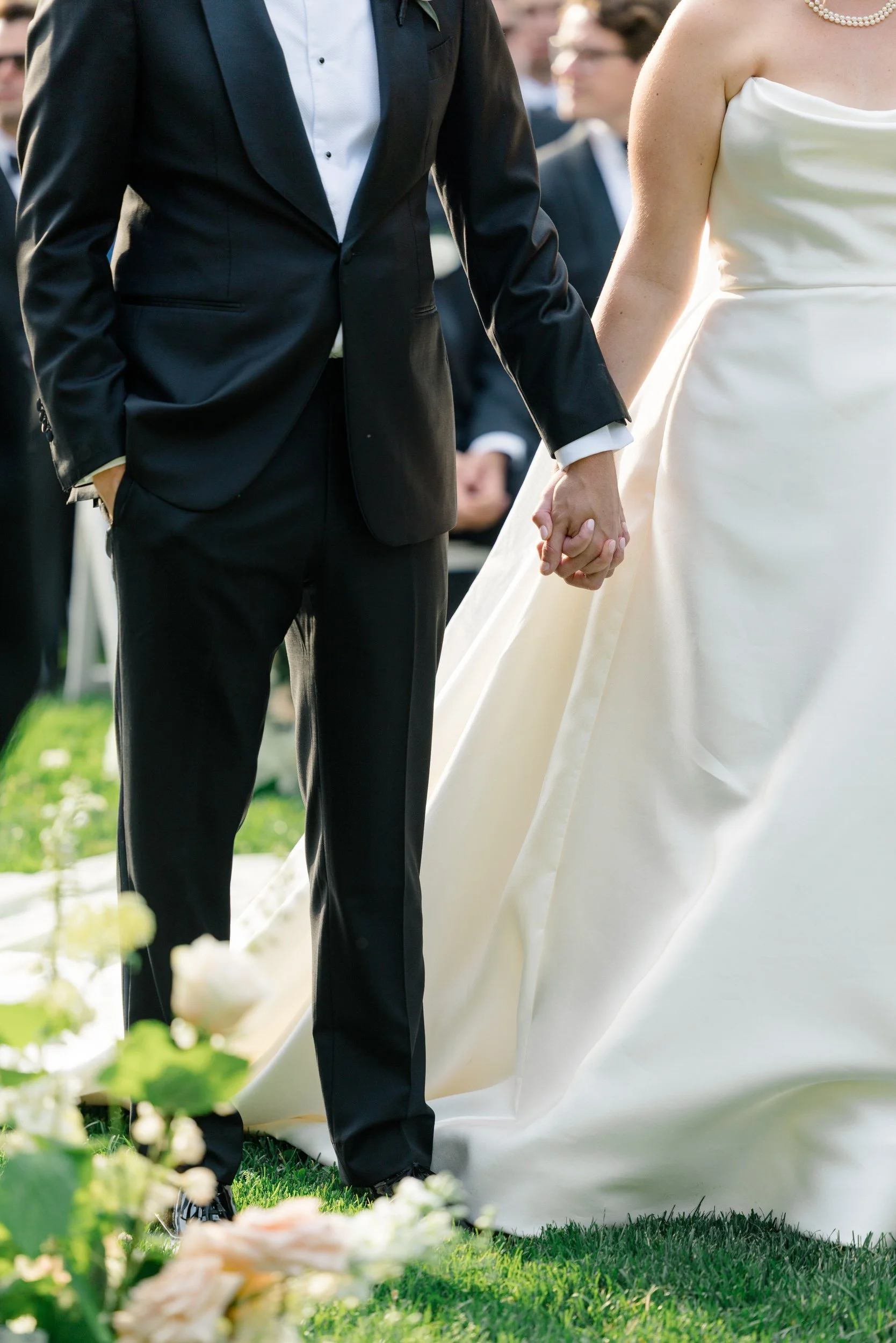 Emotional wedding ceremony in the Italian Garden at Crane Estate surrounded by lush formal gardens.