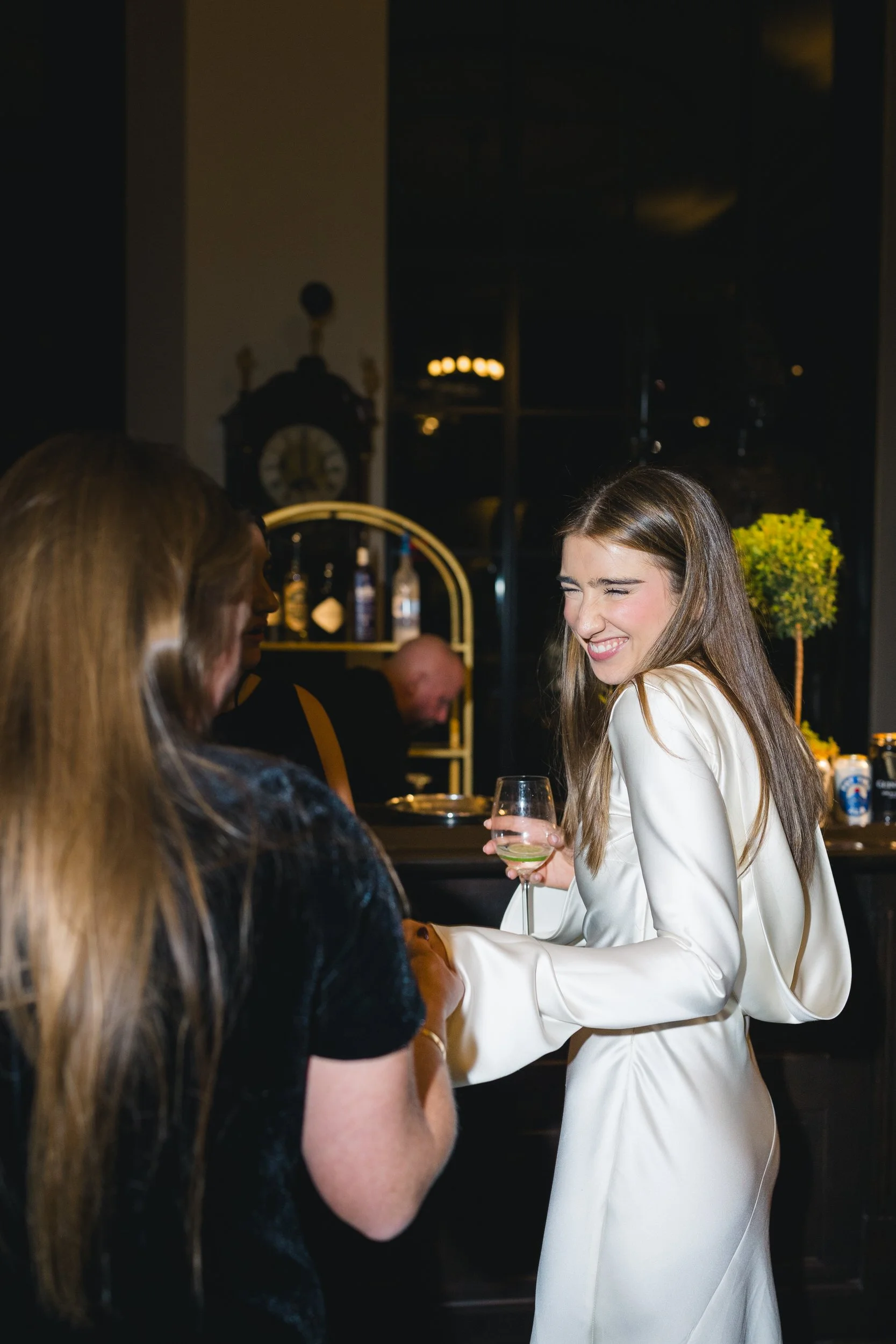 Elegant candlelit ambiance inside the Boston Athenaeum during the wedding welcome party.