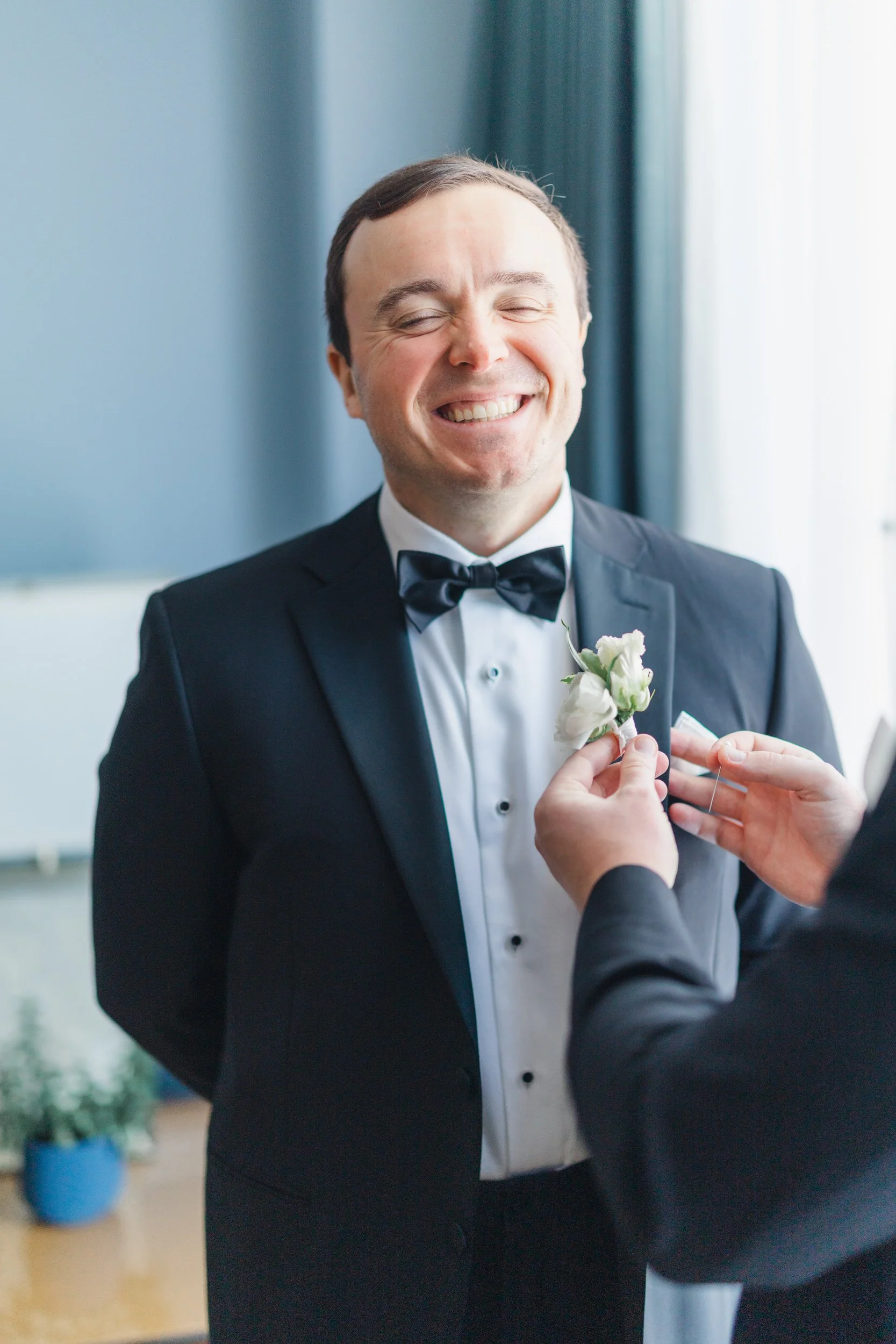 Candid groom portraits during getting ready at a Boston Harbor Hotel wedding