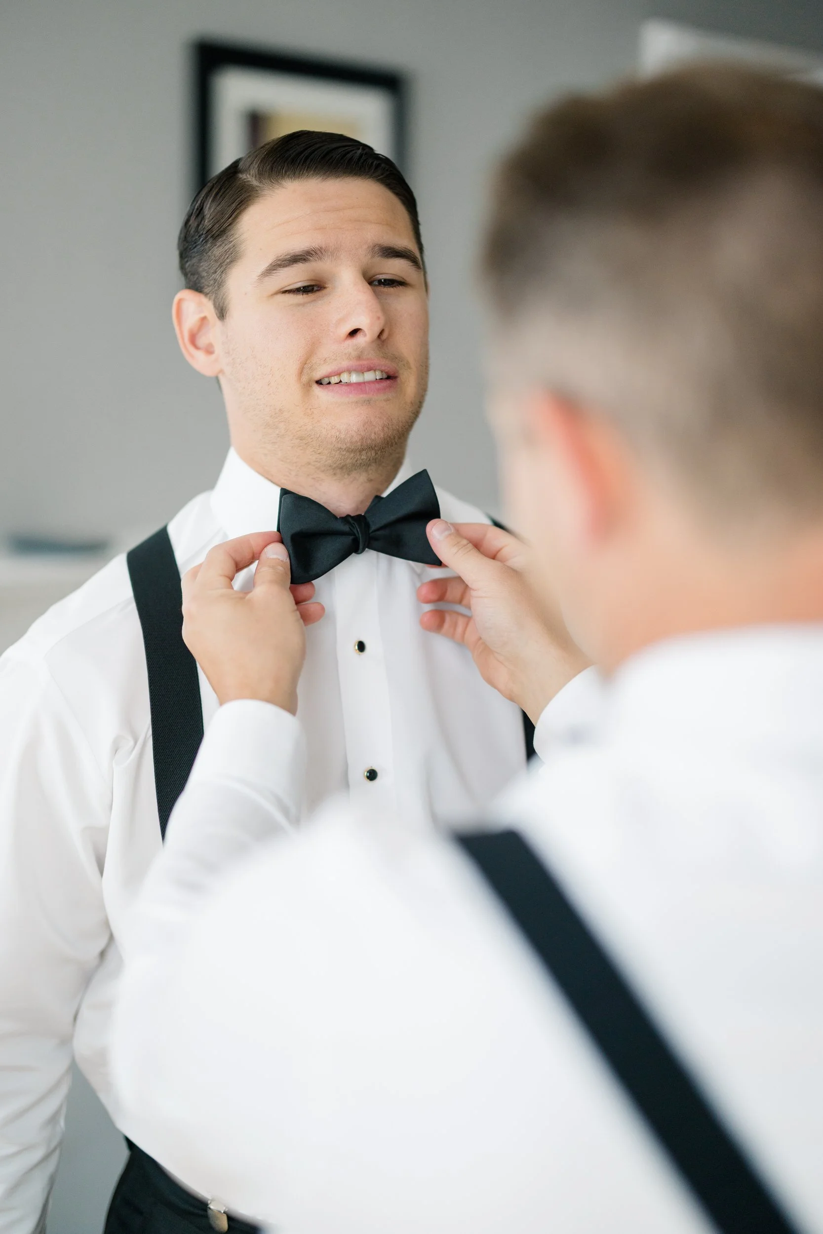 Groom adjusting his tie before a Cape Cod private estate wedding.