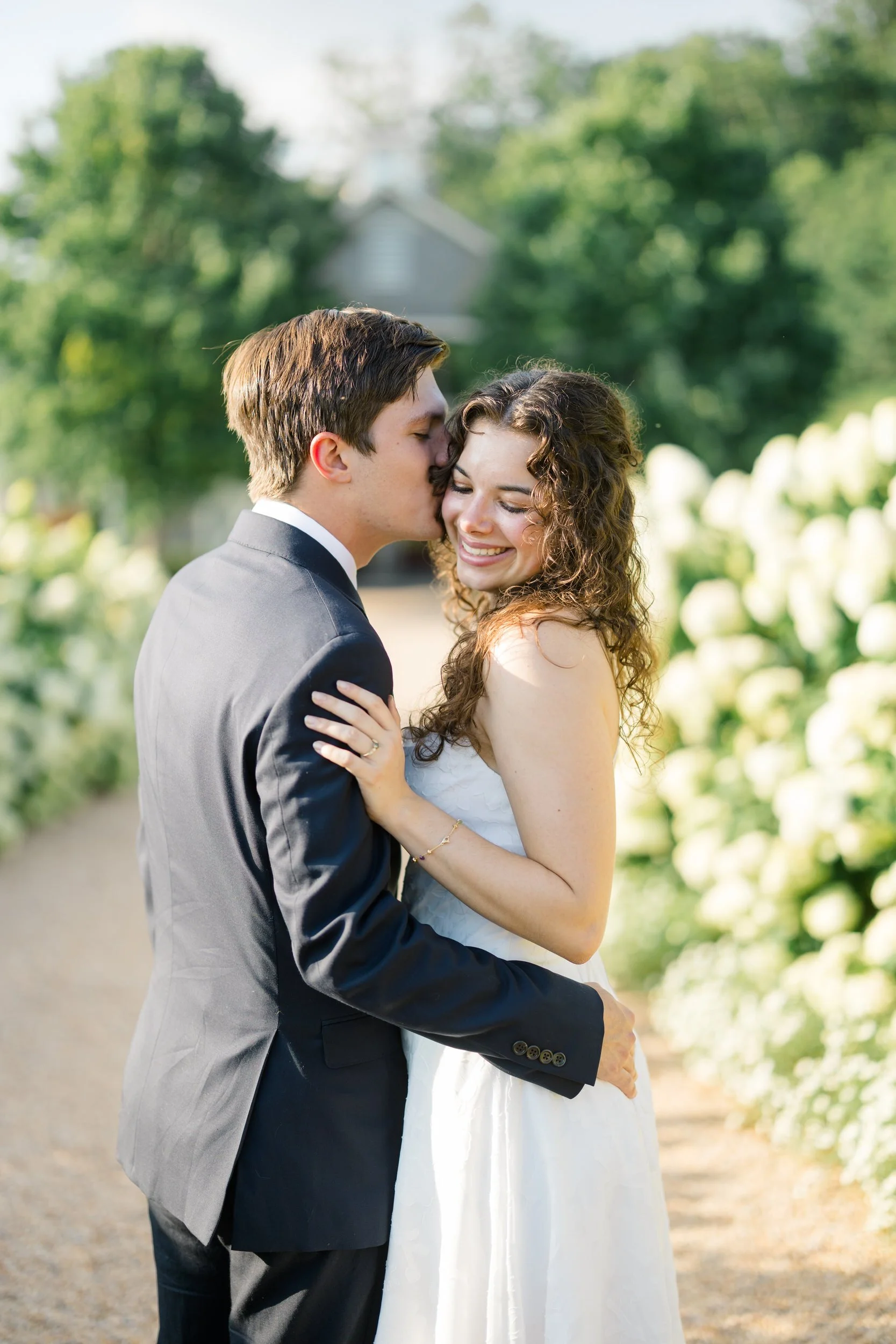 Couple embracing among the white hydrangeas at Pippin Hill Farm & Vineyards in Virginia