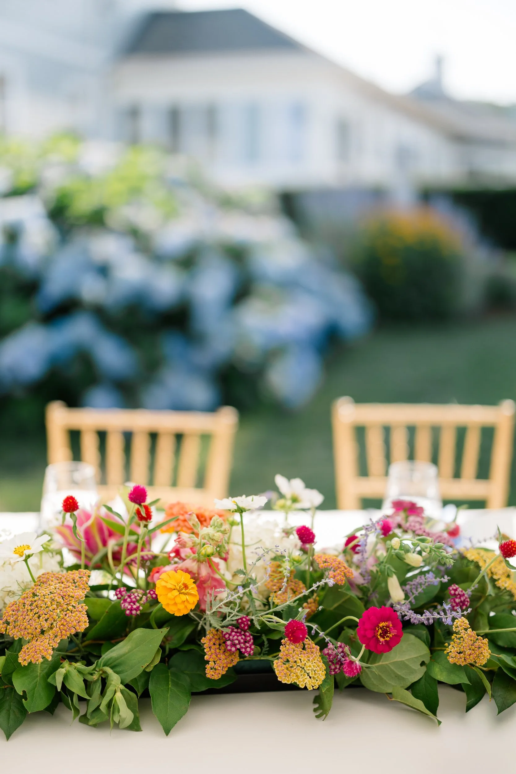 Tented wedding reception with wildflowers and hydrangeas.