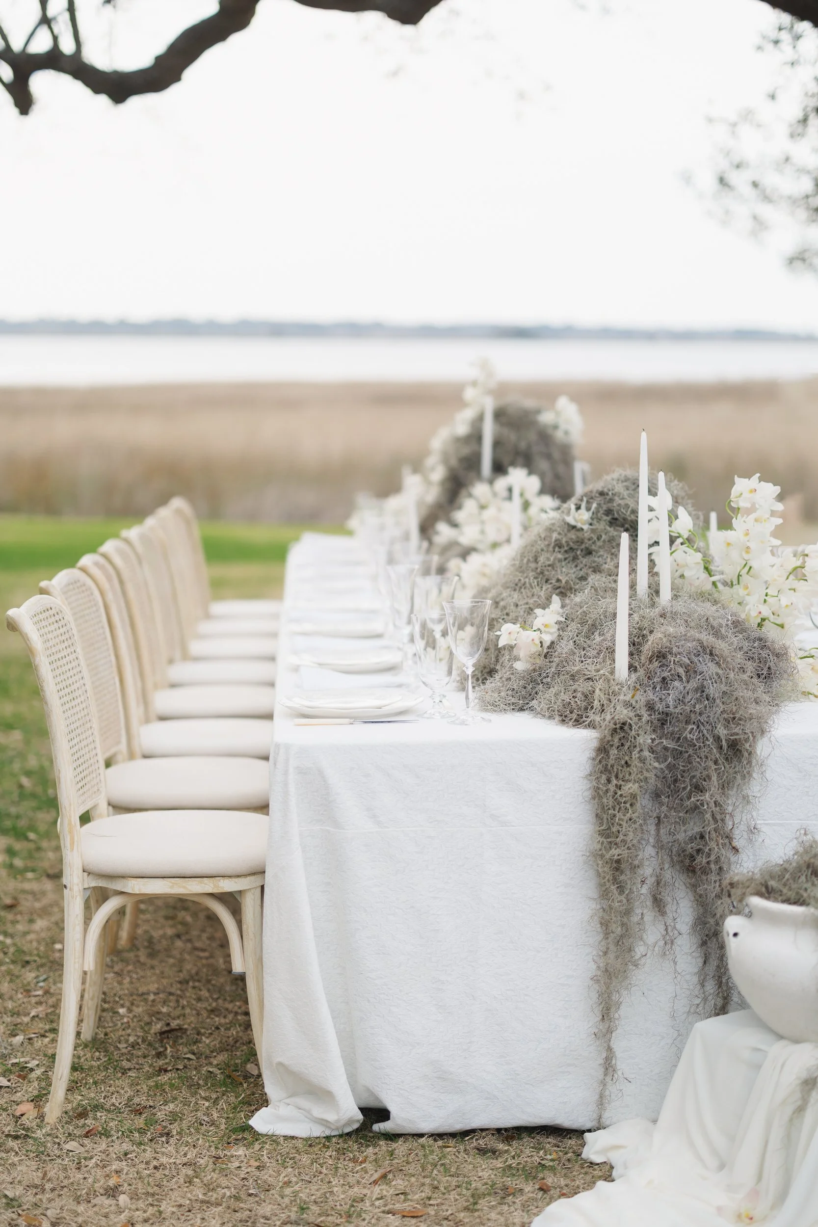 Candlelit outdoor reception tablescape overlooking the Ashley River at Lowndes Grove