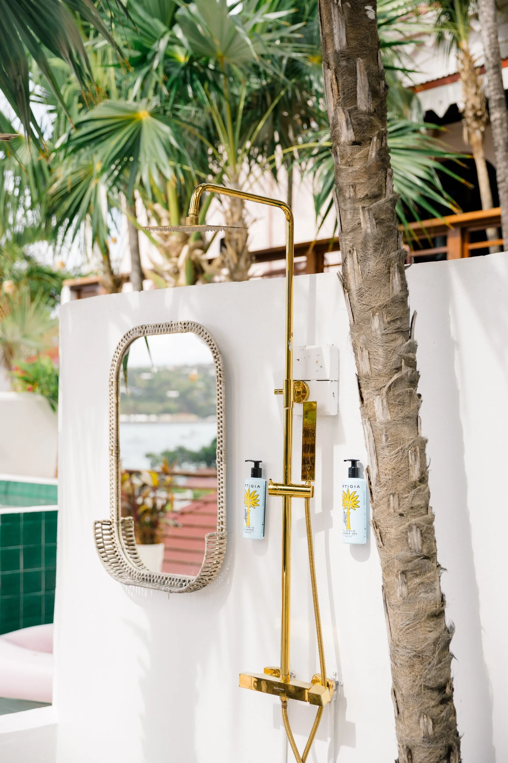 Outdoor shower surrounded by tropical greenery at The Pink Palm Hotel in St. Thomas