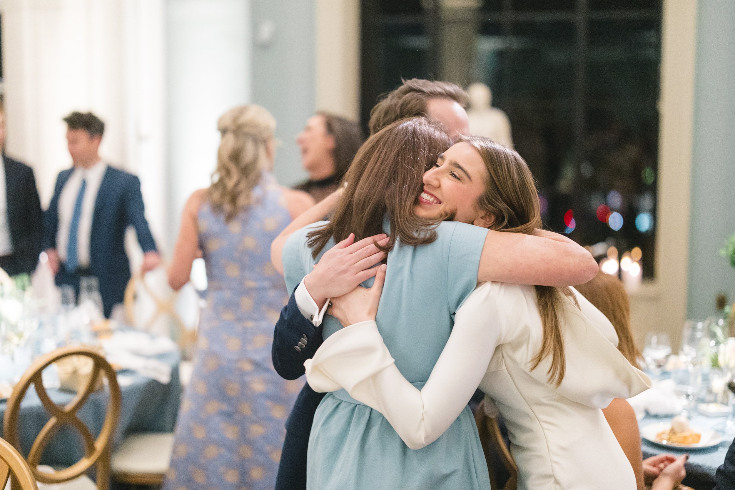 Couple greeting guests during their Boston Athenaeum welcome party.
