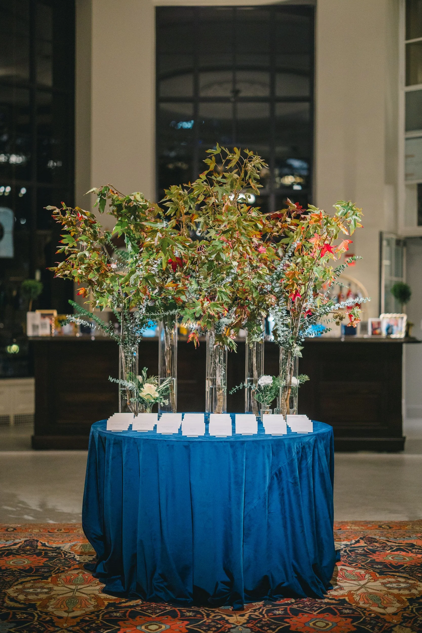 Escort cards displayed for a Boston Athenaeum wedding rehearsal dinner.