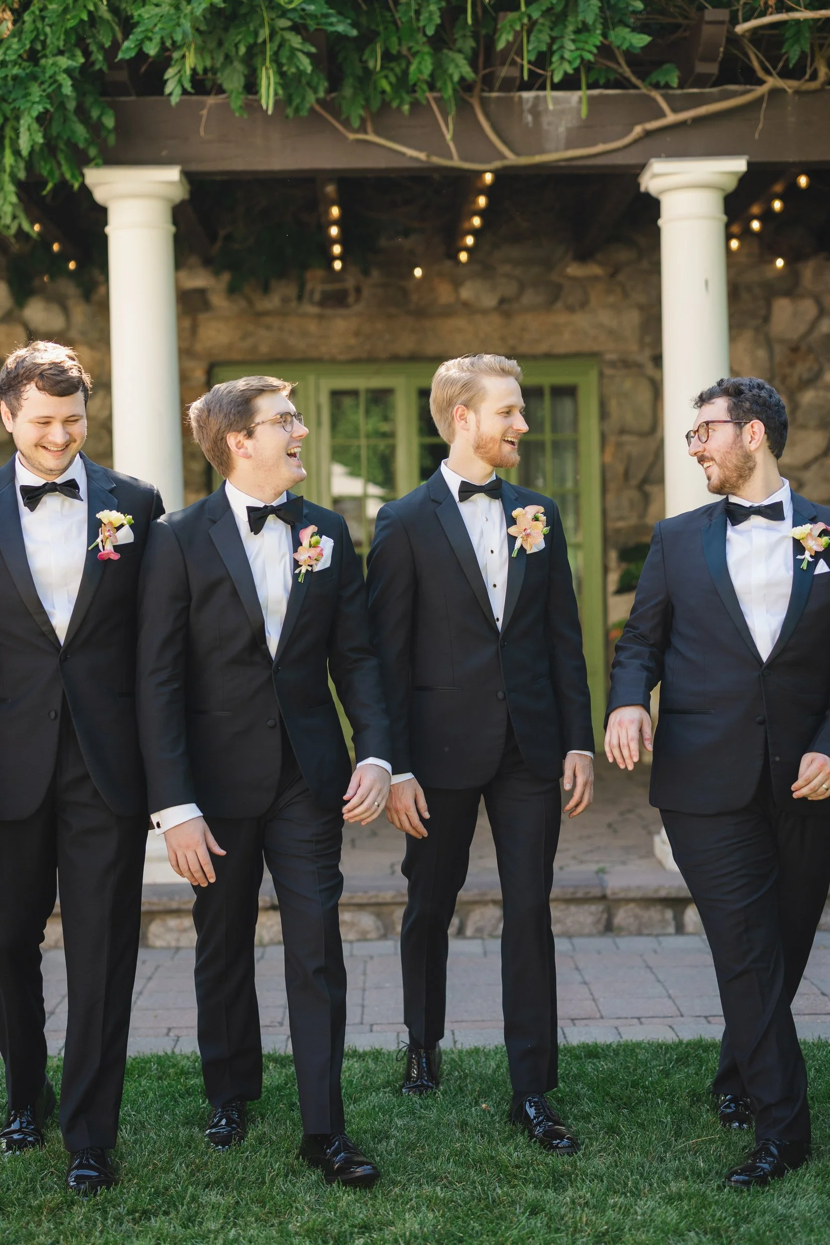 Groomsmen in black suits and bow ties at Willowdale Estate Massachusetts wedding celebration