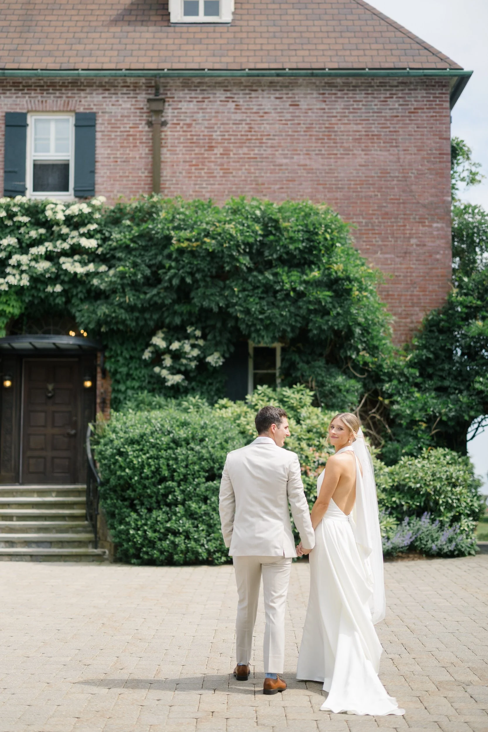 Elegant couple portraits at a coastal garden party wedding.