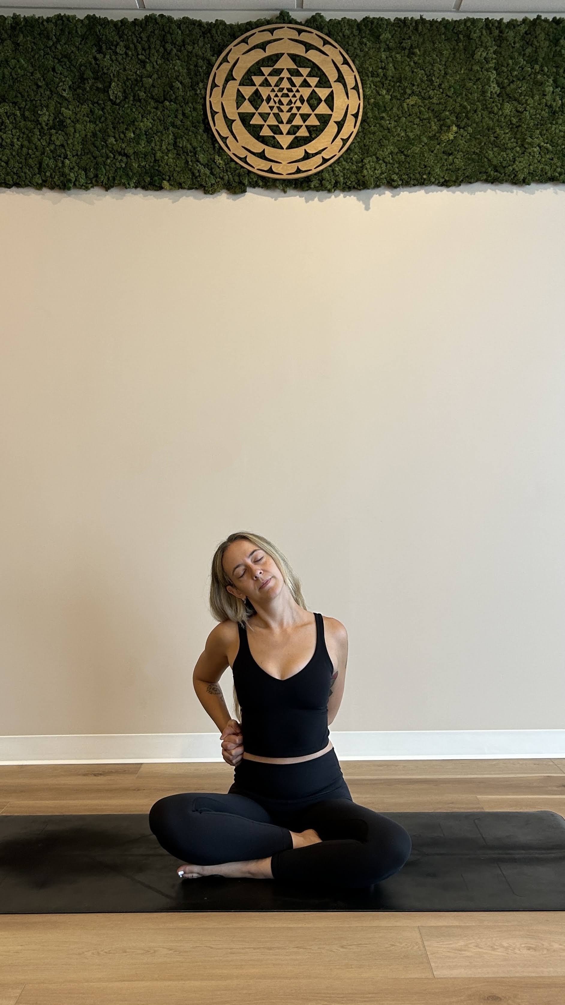 Yoga teacher demonstrating a stretch for the neck