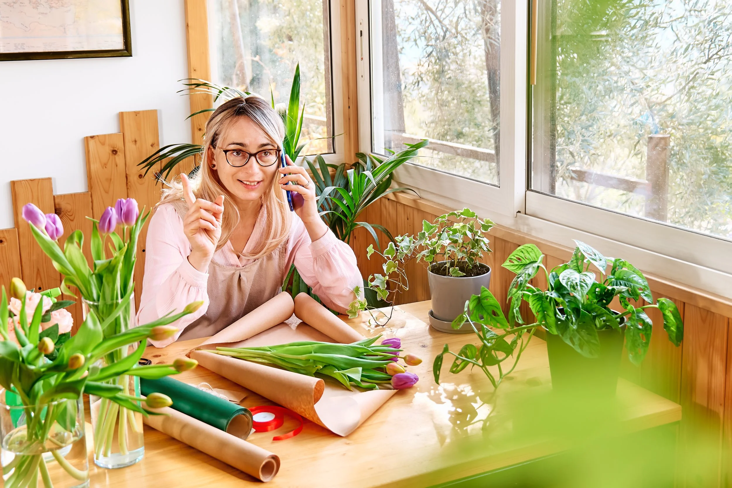 woman-florist-in-flower-shop-taking-order-by-mobil-2023-11-27-05-00-41-utc.jpg