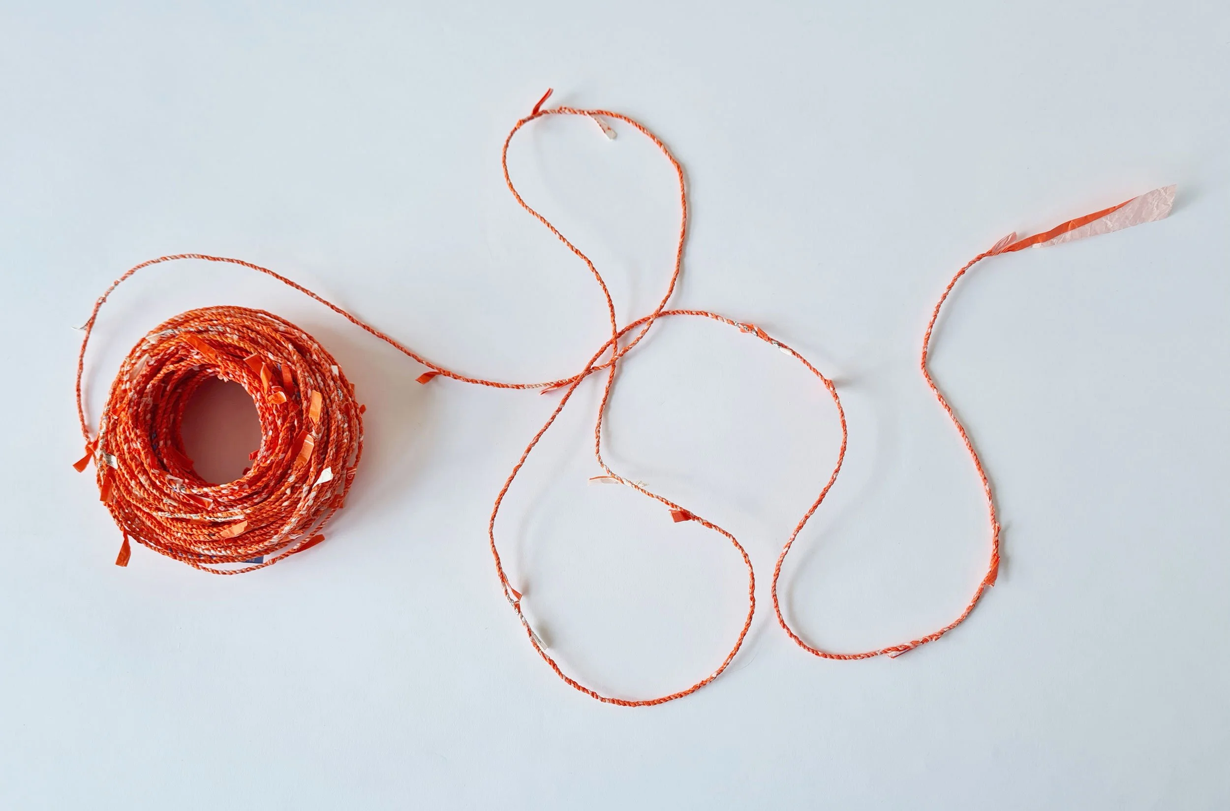 Emergency String, 2024 
Handmade cordage with discarded Who Gives A Crap 'emergency' toilet roll paper wrappers, 13cm x 13cm x 6cm 