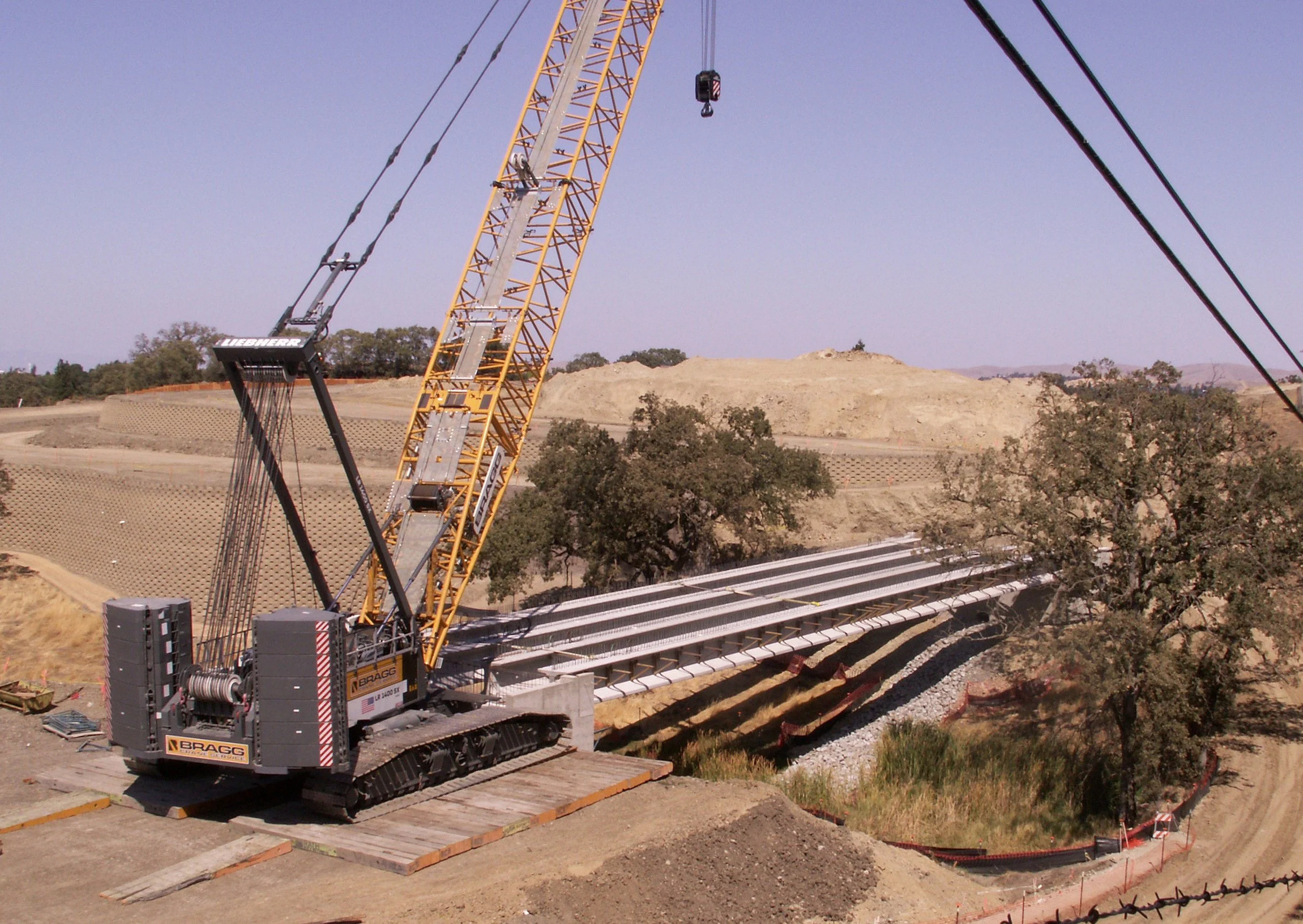 Installation of bridge beams over wetlands. 9'25