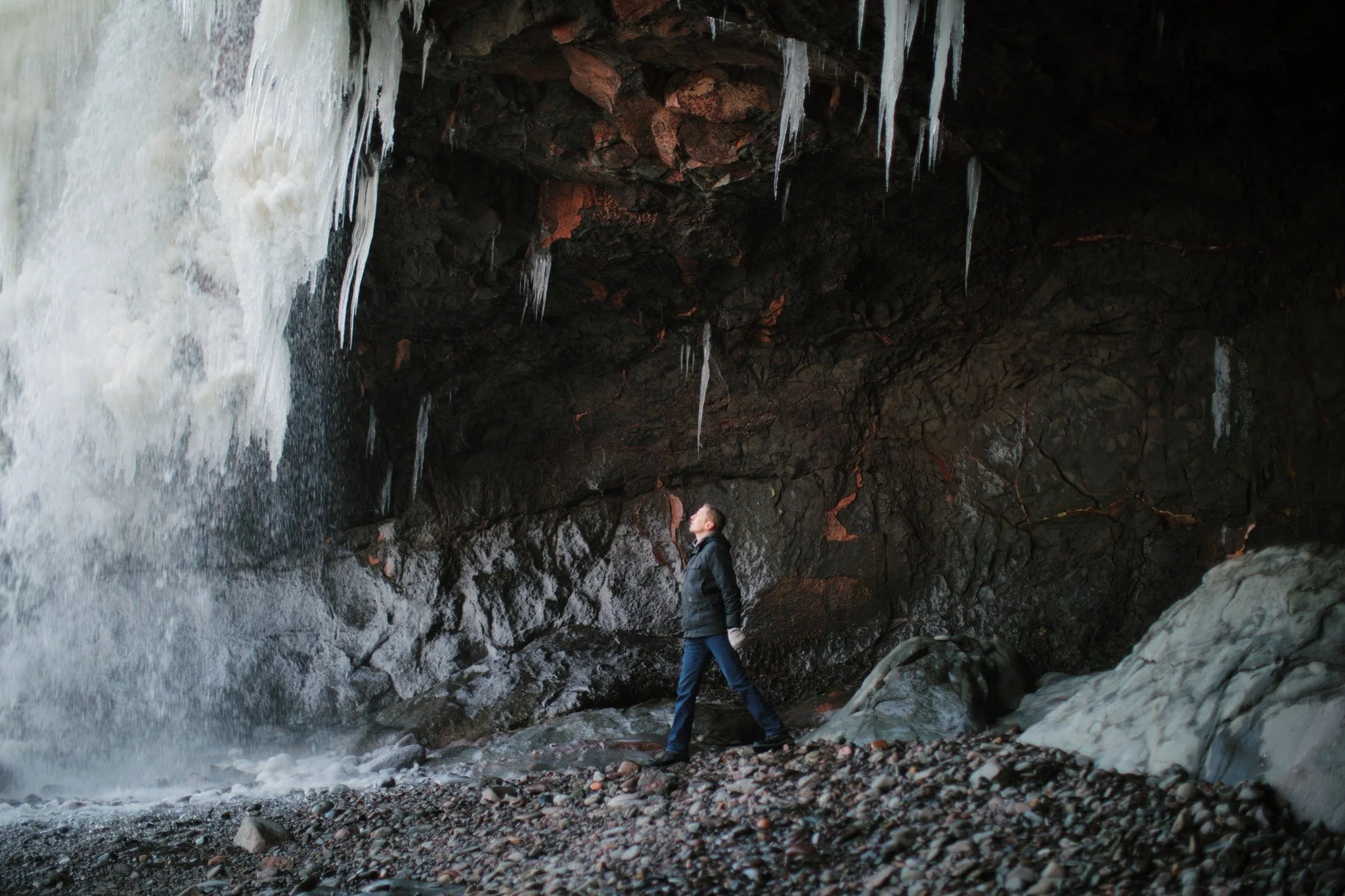 AROUND THE POINT &mdash;&mdash; The sea cave behind Healey's Brook Falls has a heavy hold on me. I'd been coming here about a decade before it first occurred to visit in winter. Now I keep on coming, curious. The tower of ice and water thundering dow