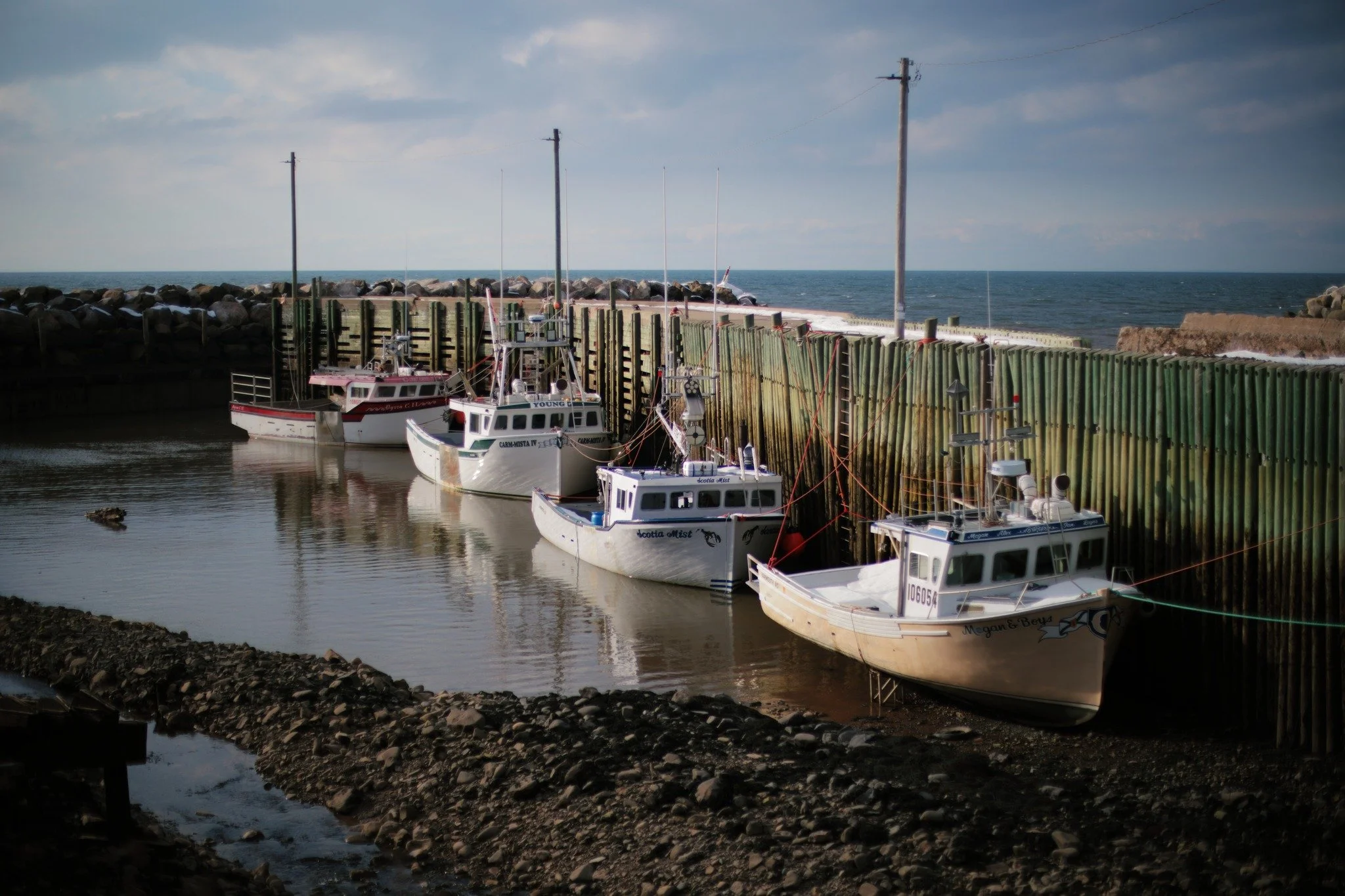 KIND OF HOME &mdash;&mdash; There is a darkness to sunlight that sees straight through me, casting shadows to hide what overcast weather never could. Citizens of this sheltered port lie low, little boats buried sleepy out of sight. I start and watch 