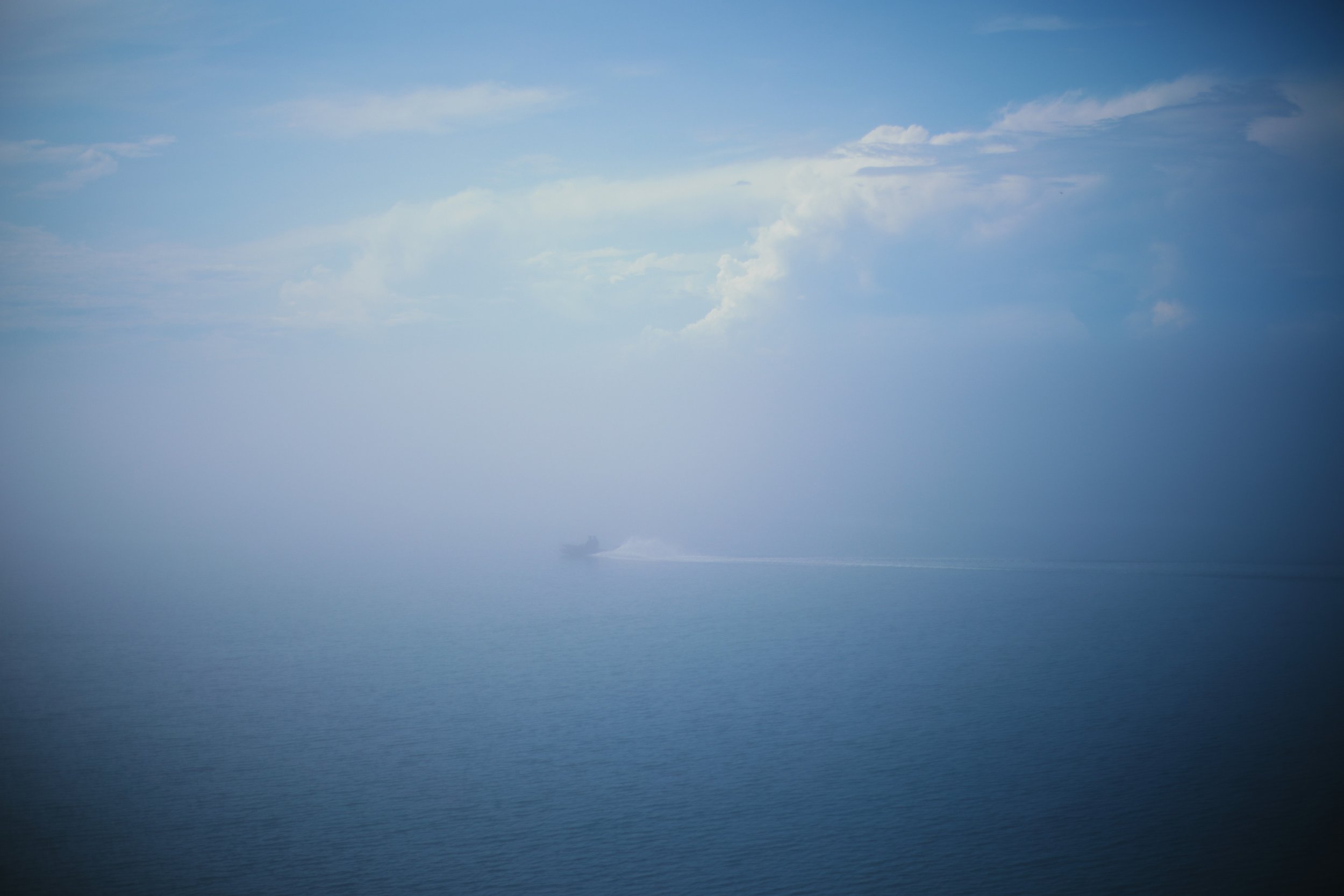 SHADOW SETTLED &mdash;&mdash; In the thin vale of fog between shore and sea, with barely enough visibility to mark their way, a motorboat cut a white line under Port Lorne wharf. It was an afternoon of threat on the horizon that never arrived. Growin