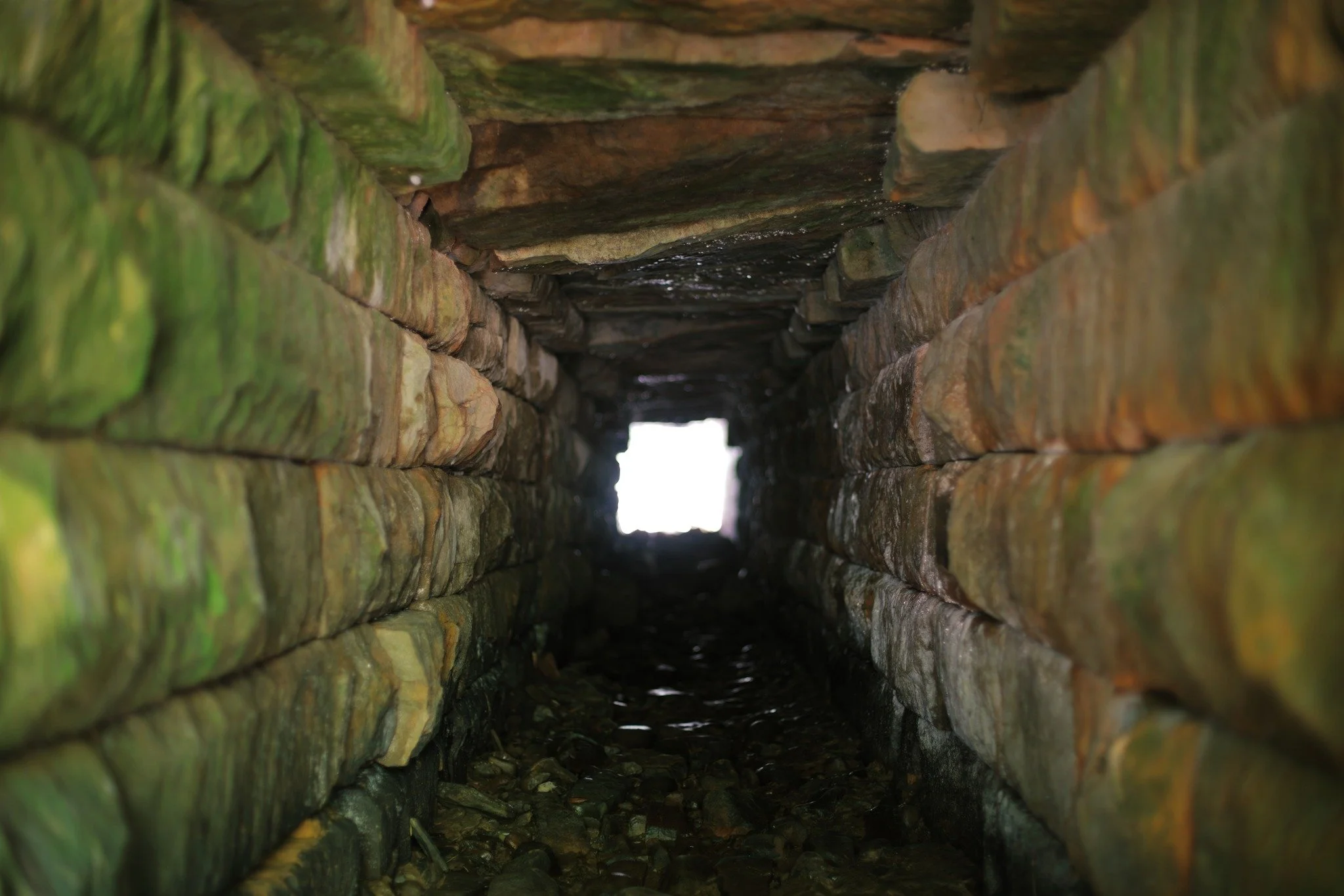 RELIC REMAINS &mdash;&mdash; Usually, when I find a stone culvert line this, it's buried beneath a railway. But here under Bluff Road, between Avonport and Hantsport, this rough and ragged tunnel provides passage for Harold's Brook. It was too small 