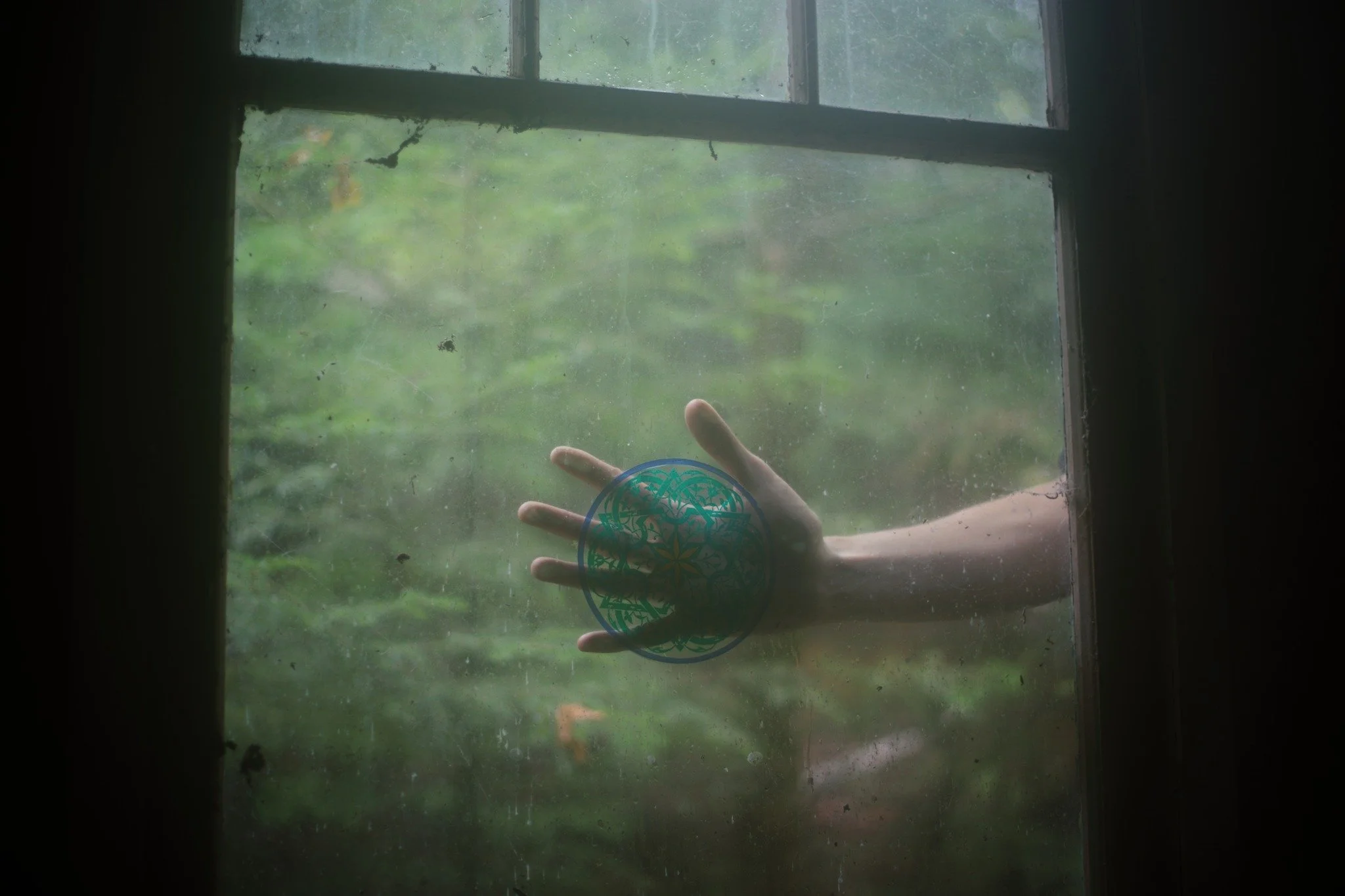 FROM HAUNTING &mdash;&mdash; Intact glass in a long-abandoned structure is a strange love of mine. The way it accumulates grime and cobwebs, retains my fingerprints between visits, draws me in to push up close and form of porthole of hands to peer th