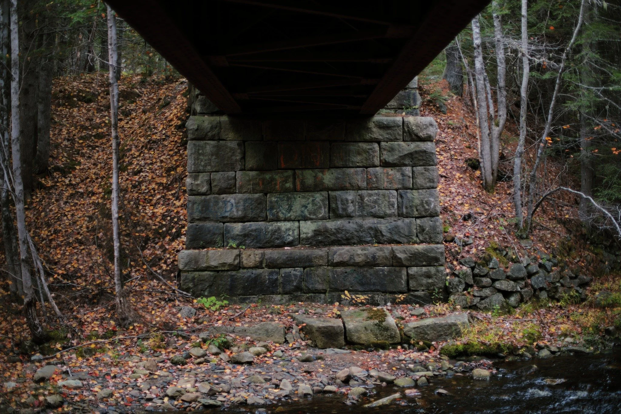 LESS LIKELY &mdash;&mdash; What's left of the old Nova Scotia Central Railway spans Indian Brook here. It's been defunct since 1983, but solid stone and steel have a lot of life to go. Been a real money saver for the off-road bunch, especially at cro