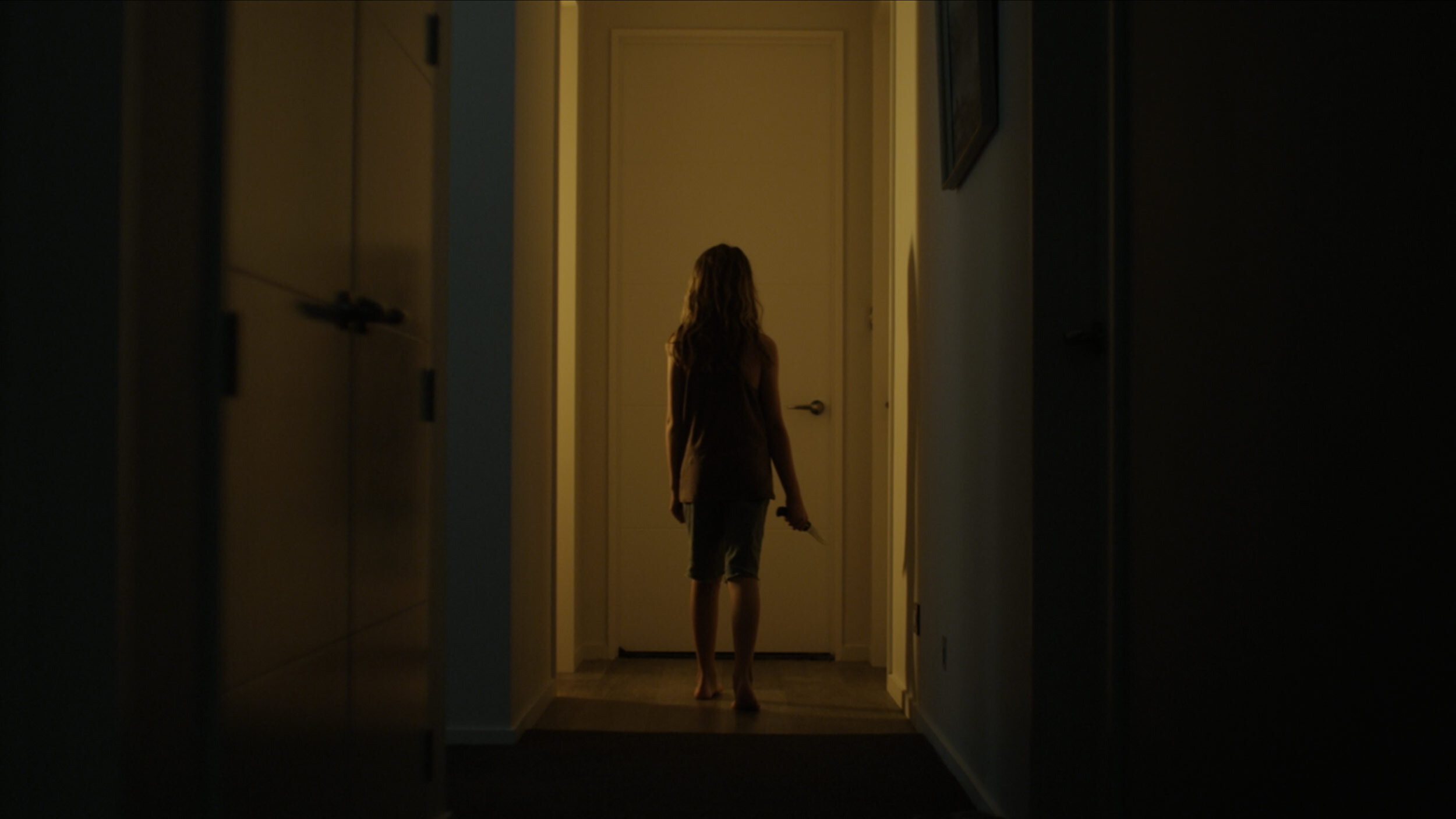 Niamh_walking_down_hallway_with_knife_020846_2.jpg