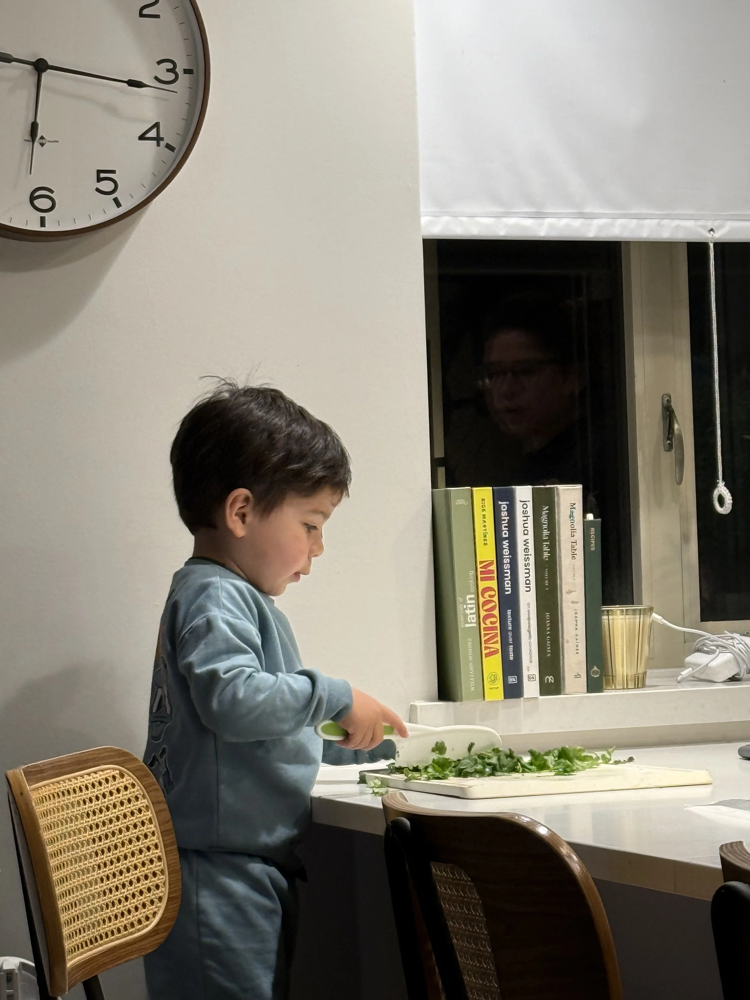 Toddler helping in the kitchen