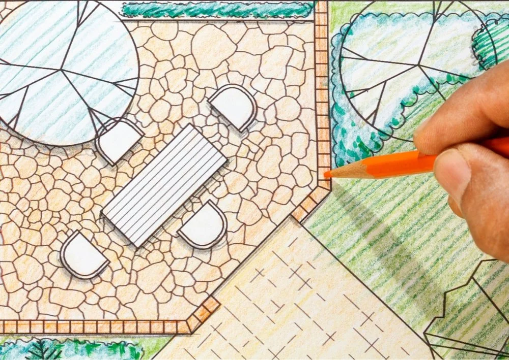 Hand drawn patio layout showing seating areas, stone paving, garden sections, and outdoor furniture placement.
