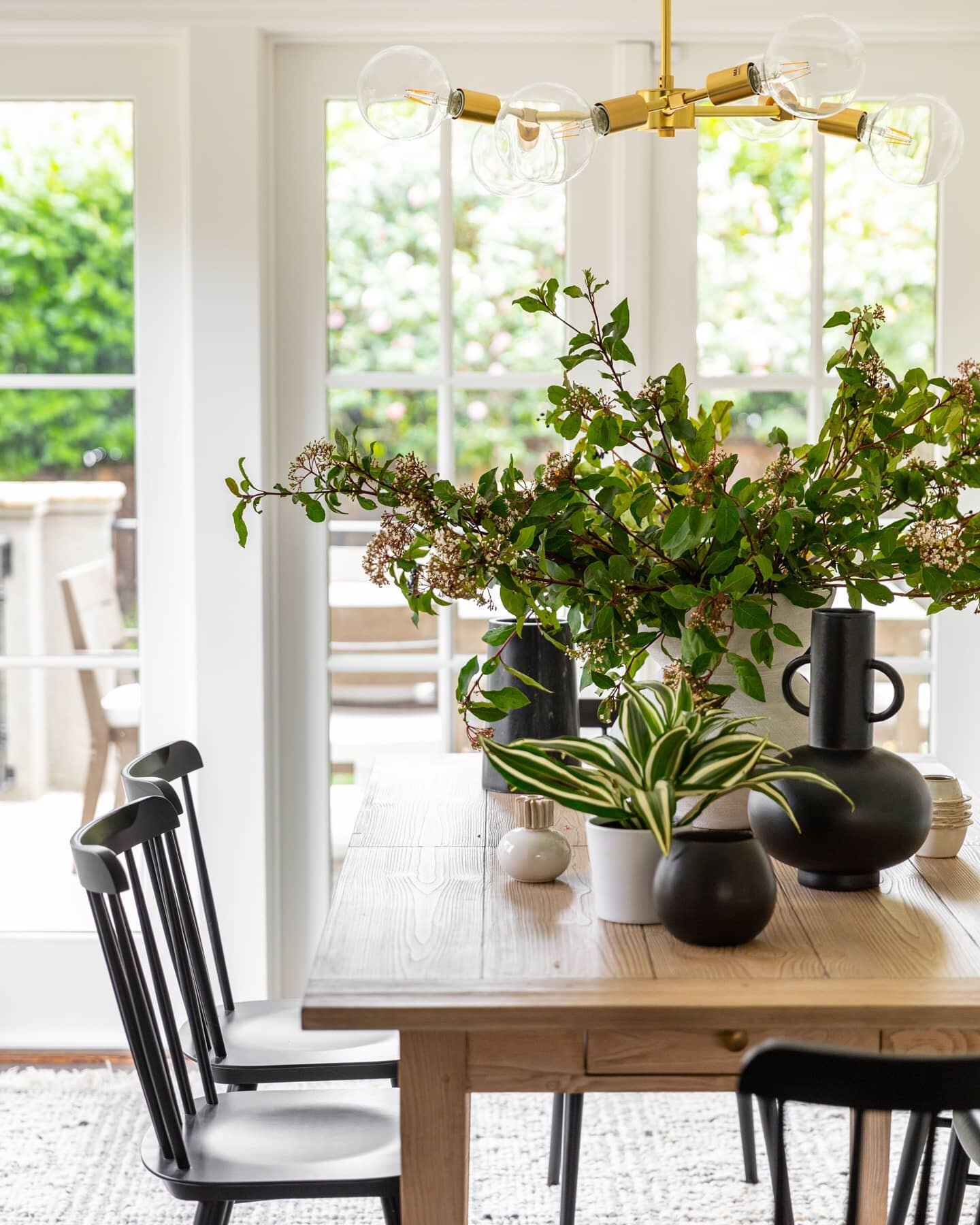 The natural lighting in this dining room is a dream for organic design elements and anyone with a green thumb! The contemporary design in this project was elevated to maintain coastal energy while incorporating open spaces and dynamic color. The plan