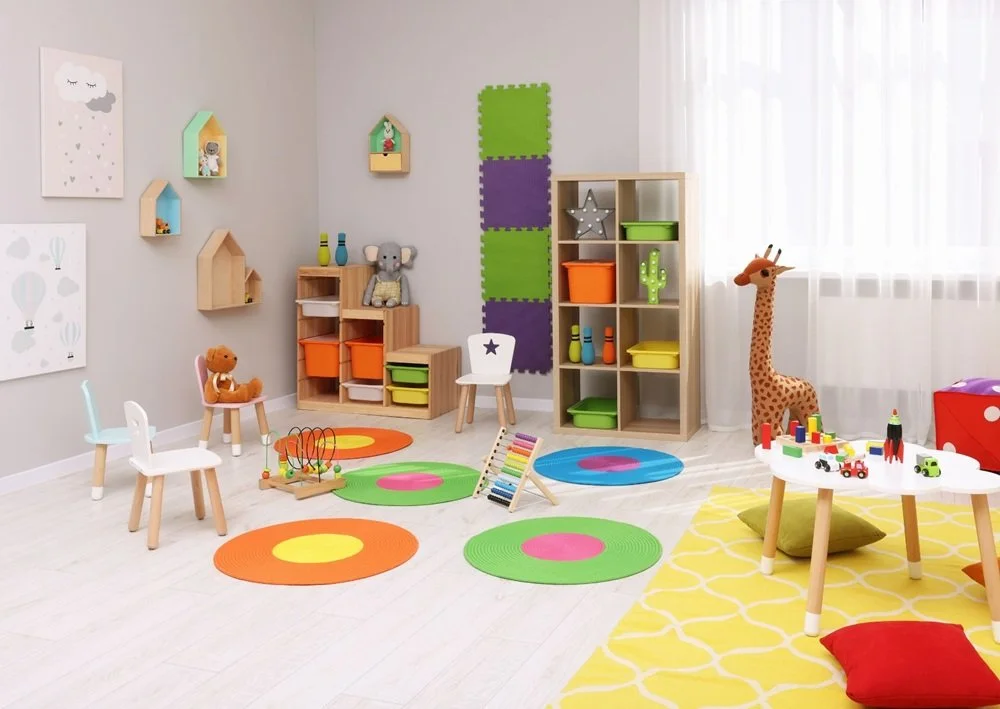 Colorful playroom with rugs, shelves, toys, and fun learning areas for children.