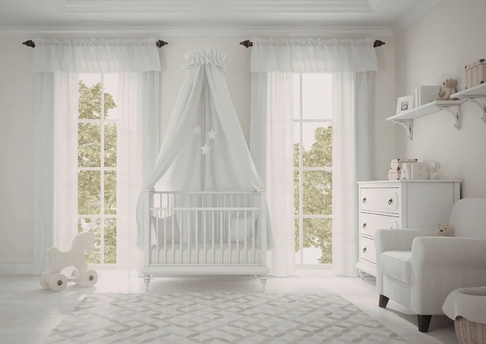 Bright white nursery with canopy crib, sheer curtains, rocking toy, and airy minimalist styling.