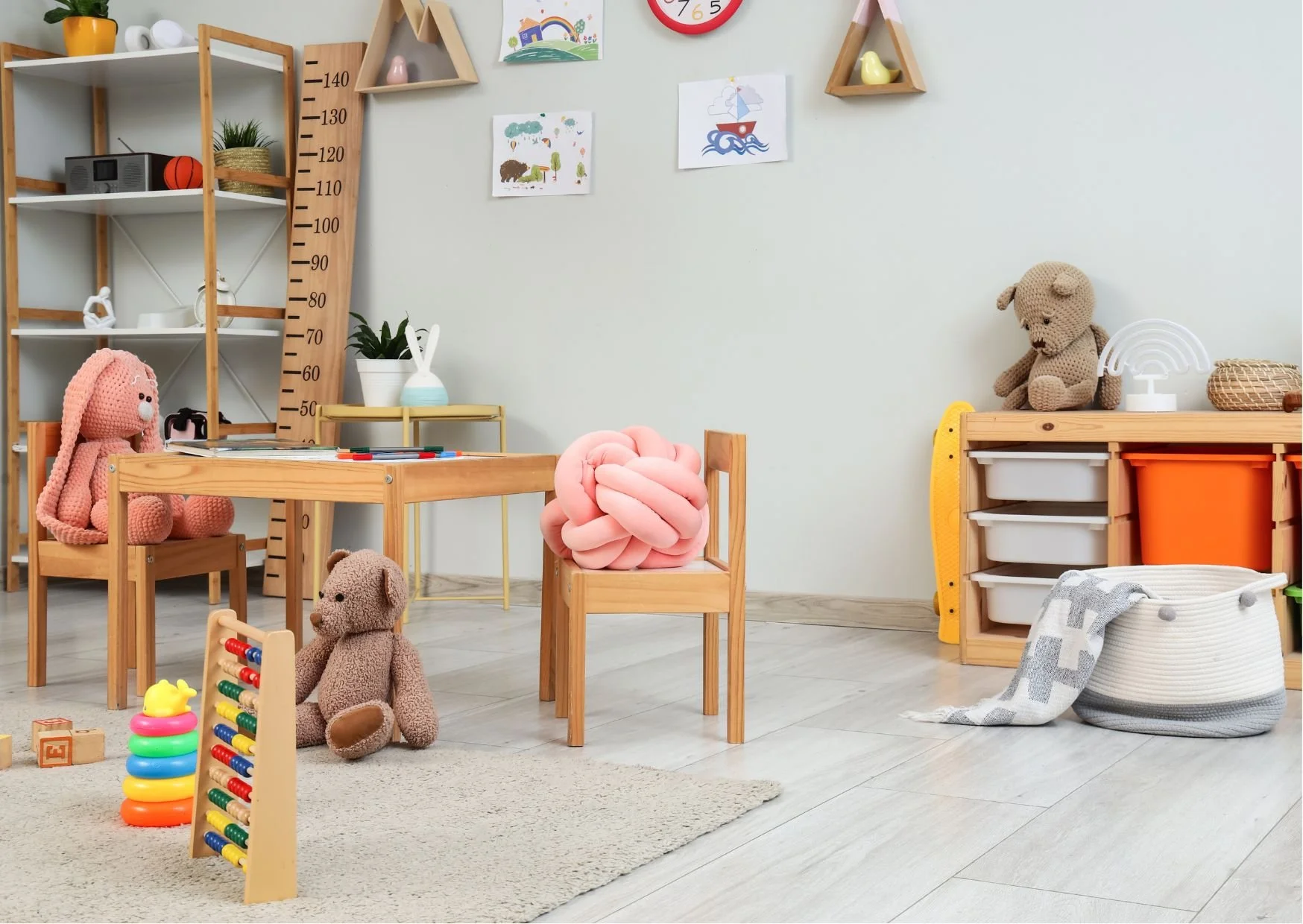 Bright playroom with wooden furniture, teddy bears, abacus, and colorful learning toys.