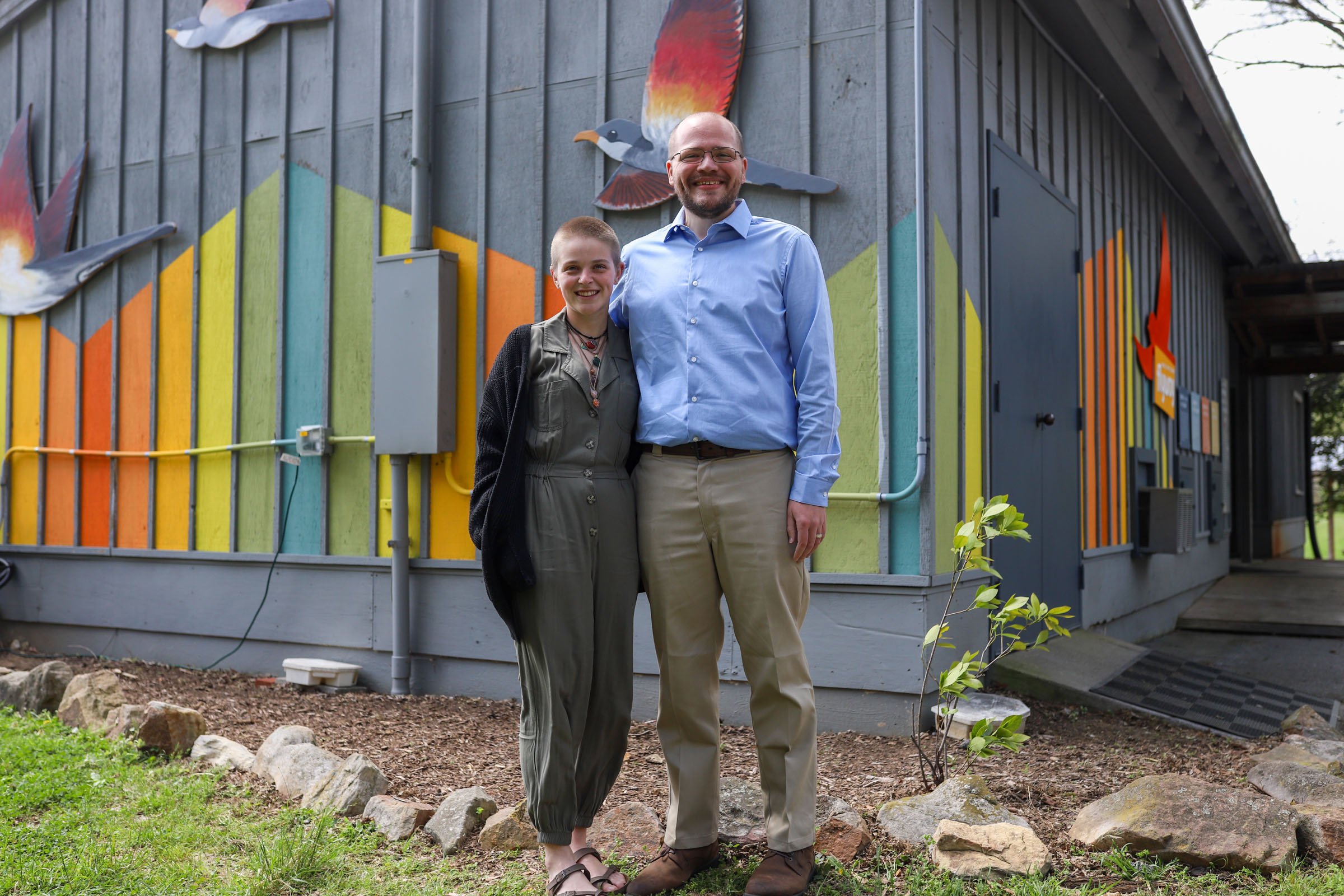  Staff photo by Olivia Ross  / Gus Gaston, one of the artists, stands with Graphic Design professor Derek Witucki at the sight of the new mural, "Reflection Flyaway," at Reflection Riding Arboretum and Nature Center on April 7, 2022. The mural was cr