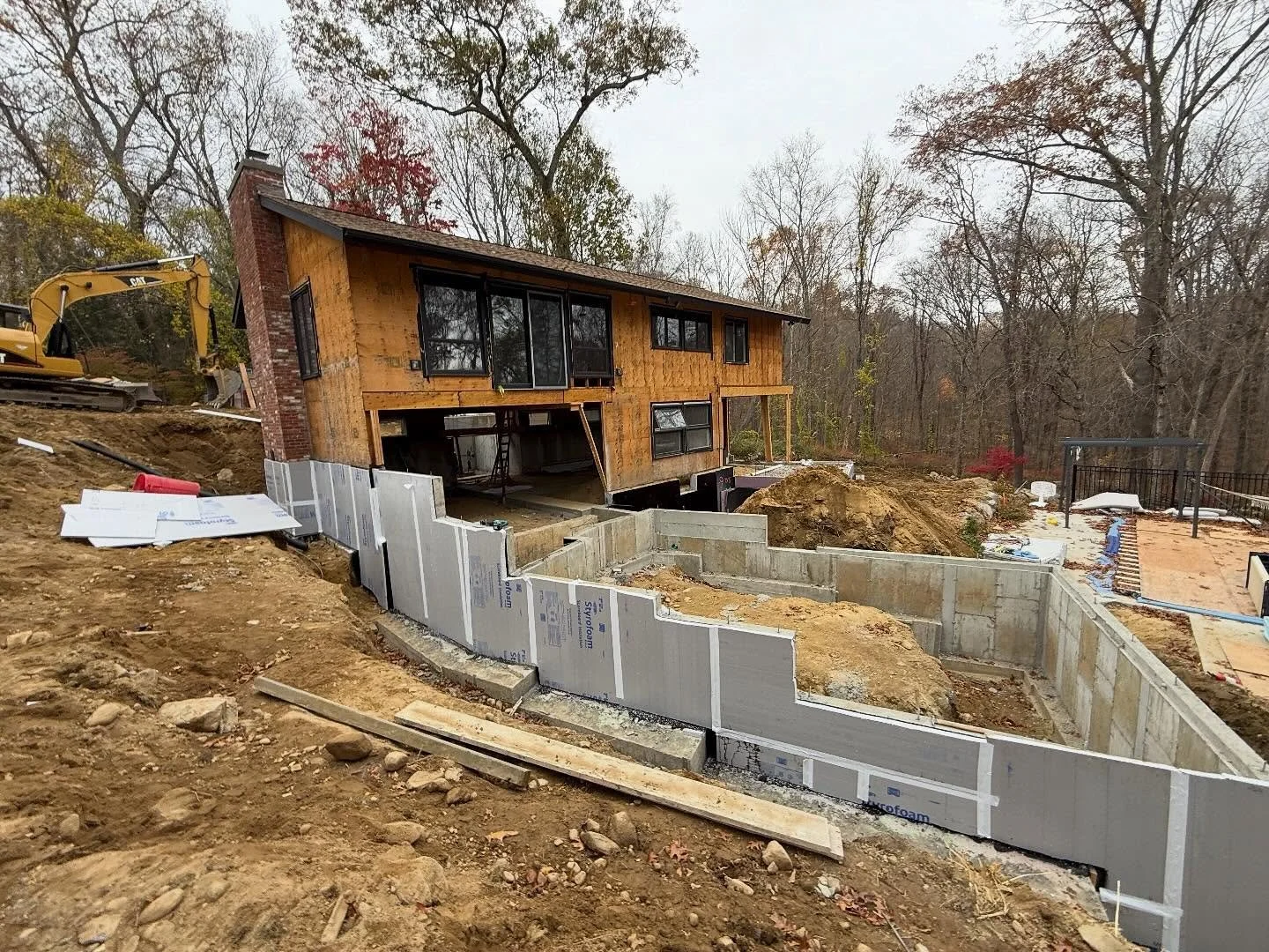 A Modern Renewal in the Woods.
Excavation and foundation work mark the beginning of a complete transformation for this mid-century home, where clean geometry meets the quiet rhythms of the surrounding forest. The new addition will expand the living s