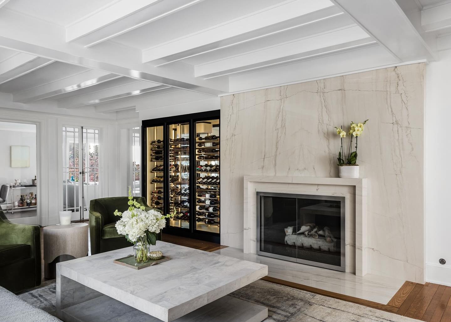 Presenting a fresh perspective on modern living in our  Hobson Street project. This home features a striking wine cellar @thewinesquare with transparent views that seamlessly connect the living and dining spaces. The new marble fireplace surround add
