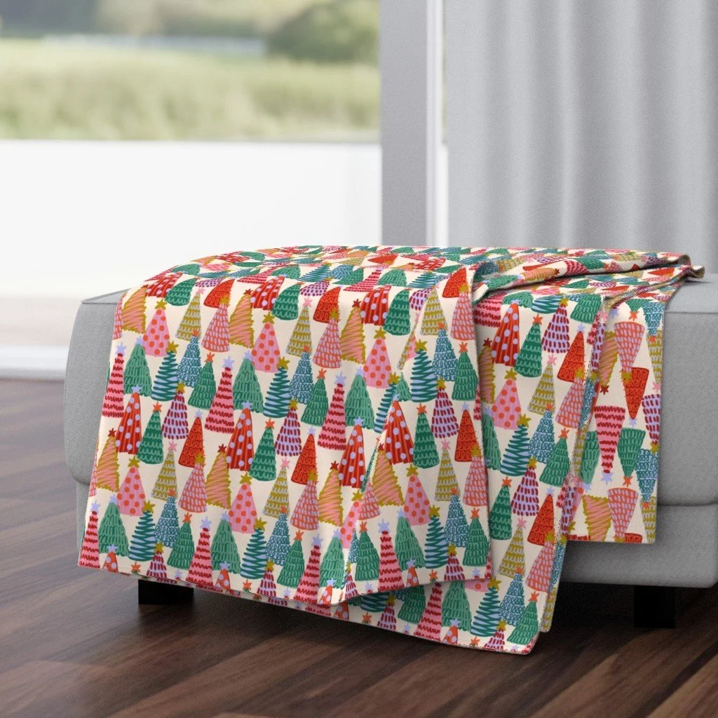 Jolly & Bright: Painted Christmas Tree Forest in Pink Red and Green on a throw blanket by Spoonflower, copyright Sandra Hutter.