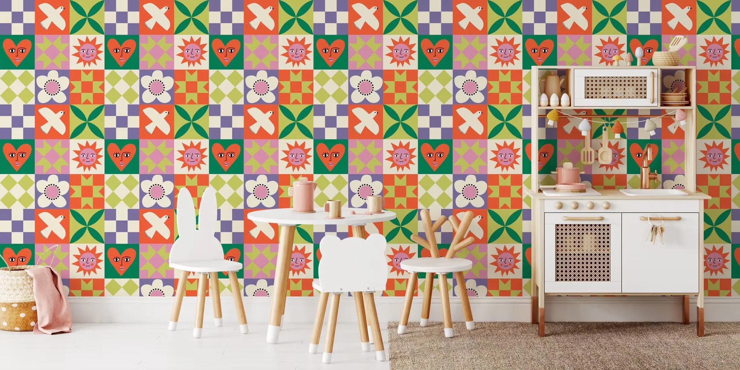 Patchwork quilt block wallpaper with a dove, smiling sun and heart faces in a playroom with a play kitchen, copyright Sandra Hutter.