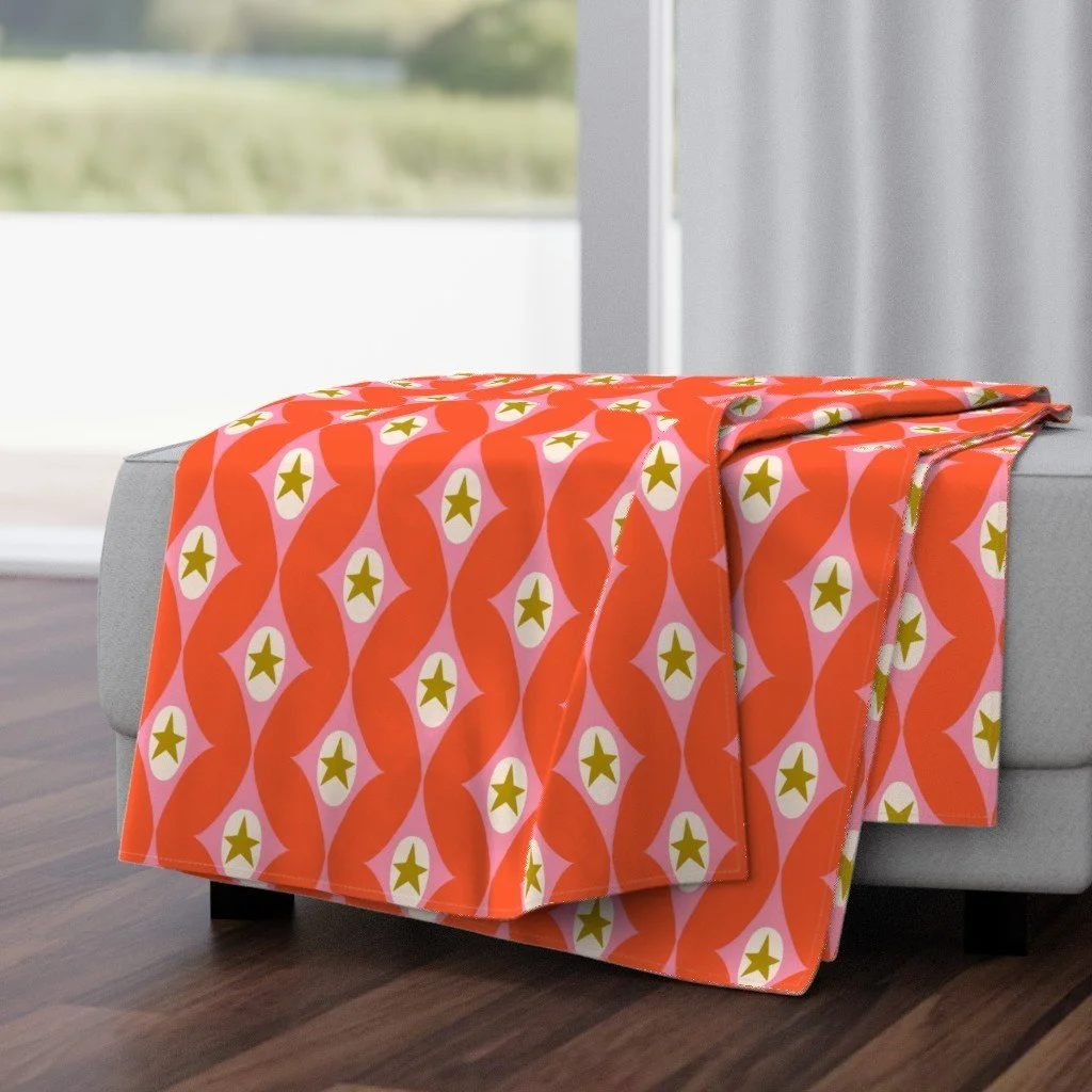 Jolly & Bright: Retro Star Diamonds in Tangerine and Pink on a throw blanket by Spoonflower, copyright Sandra Hutter.