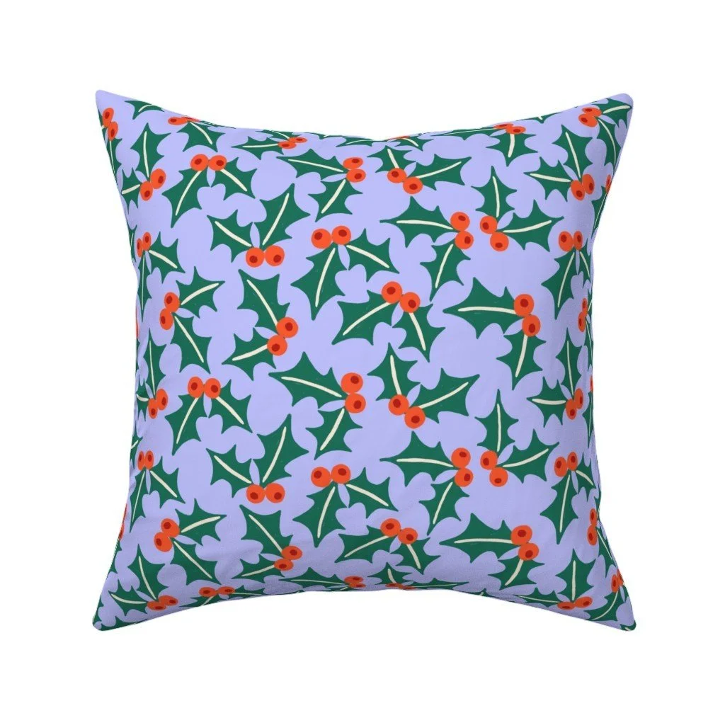Jolly & Bright: Tossed Holly Leaves and Berries on Lavender on a throw pillow by Spoonflower, copyright Sandra Hutter.