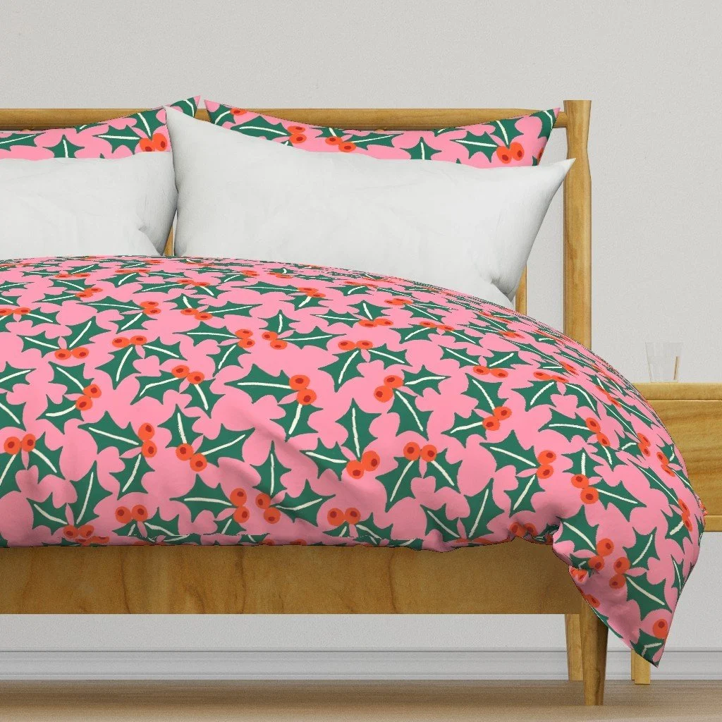 Jolly & Bright: Tossed Holly Leaves and Berries on Pink on a duvet cover by Spoonflower, copyright Sandra Hutter.